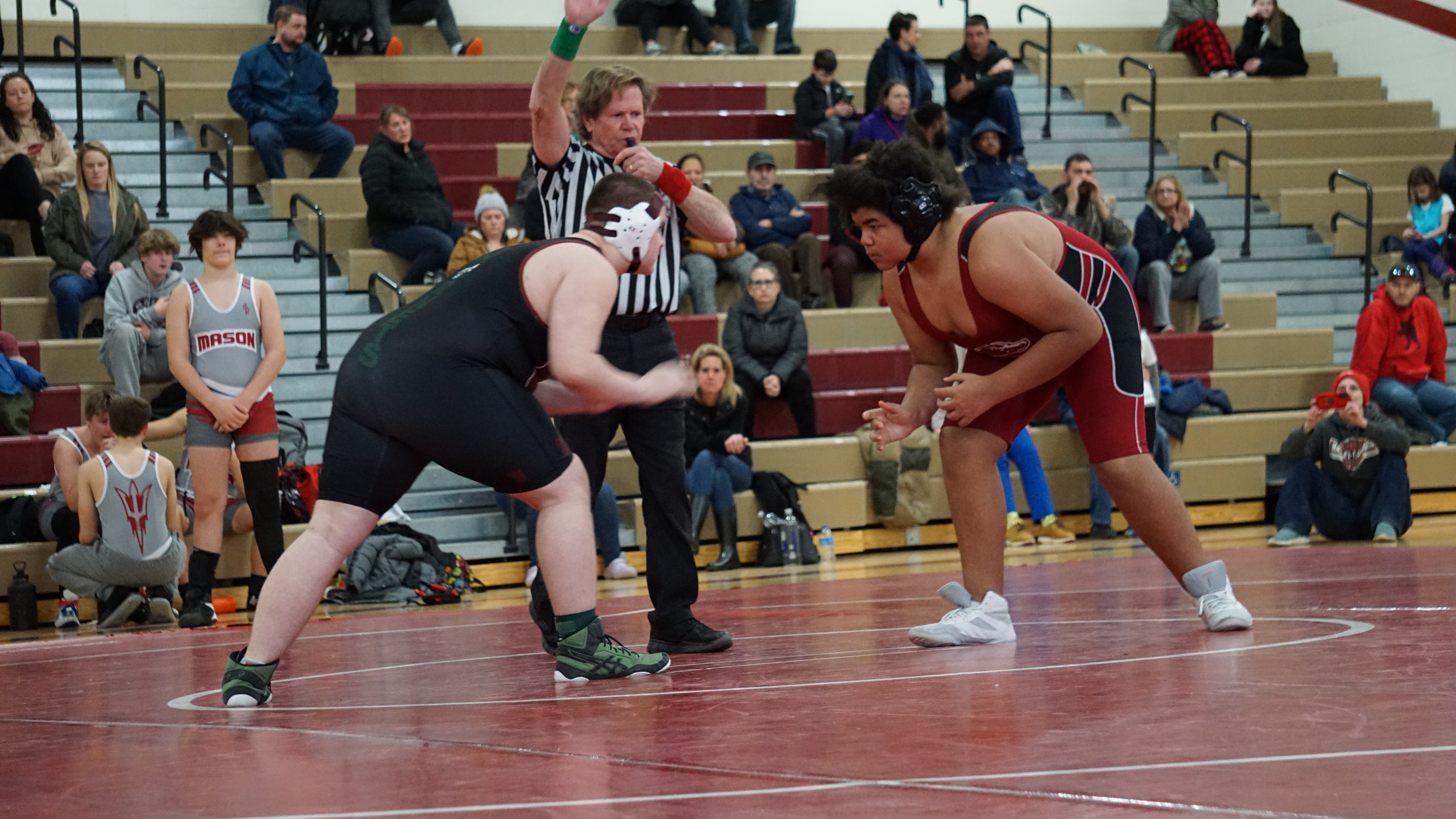 wrestlers facing off on matt at meet