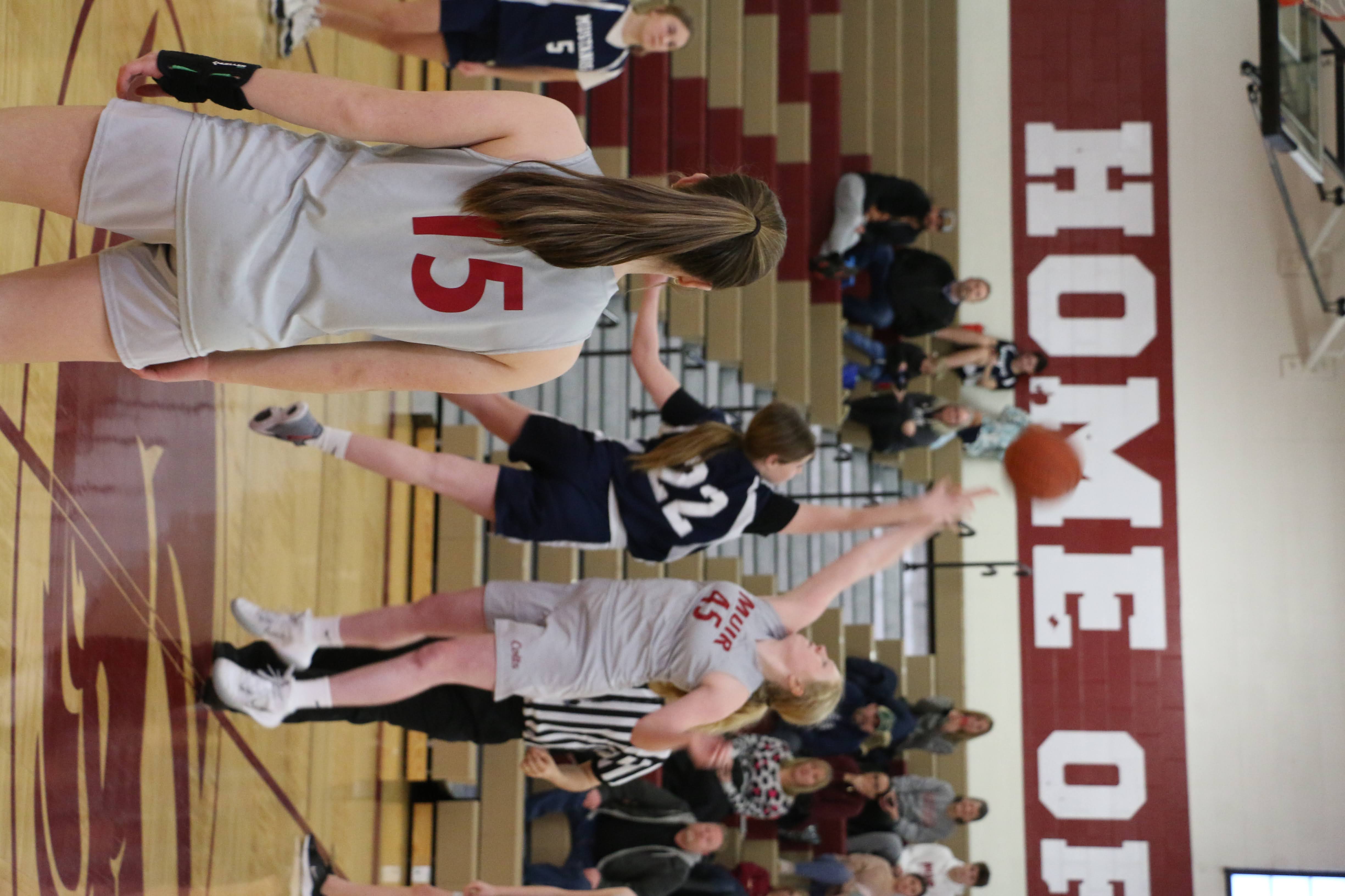 girl basketball players taking shot