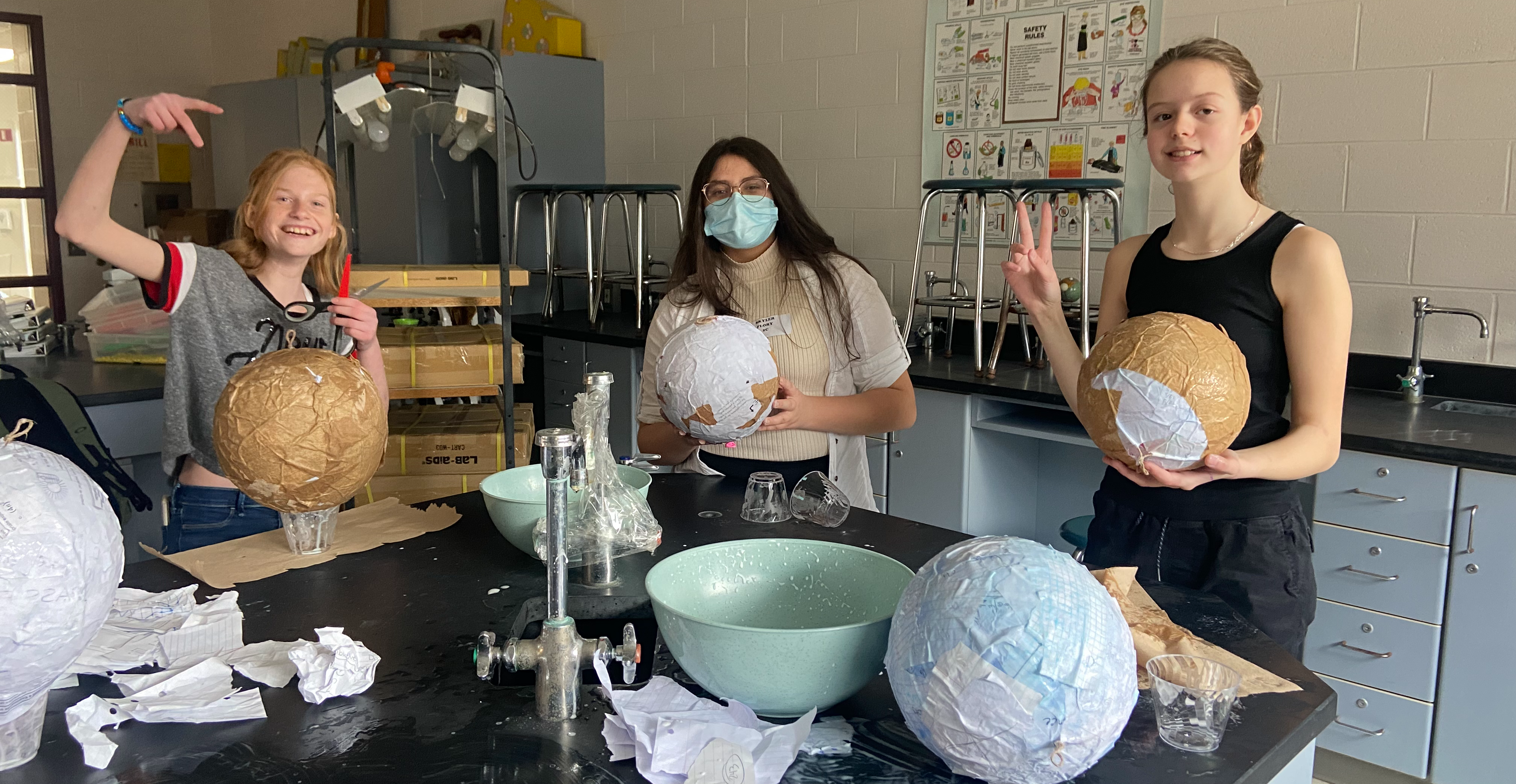 3 girls making paper mache balloons