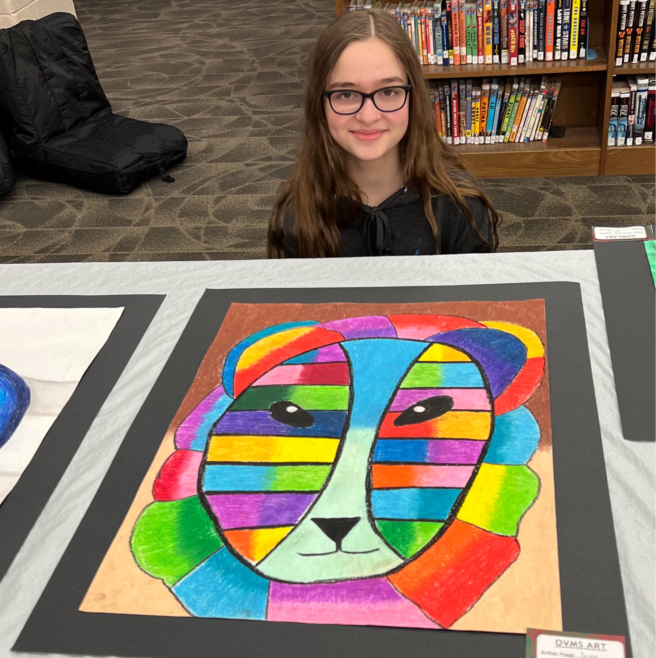 Girl with colorful drawing of lion face