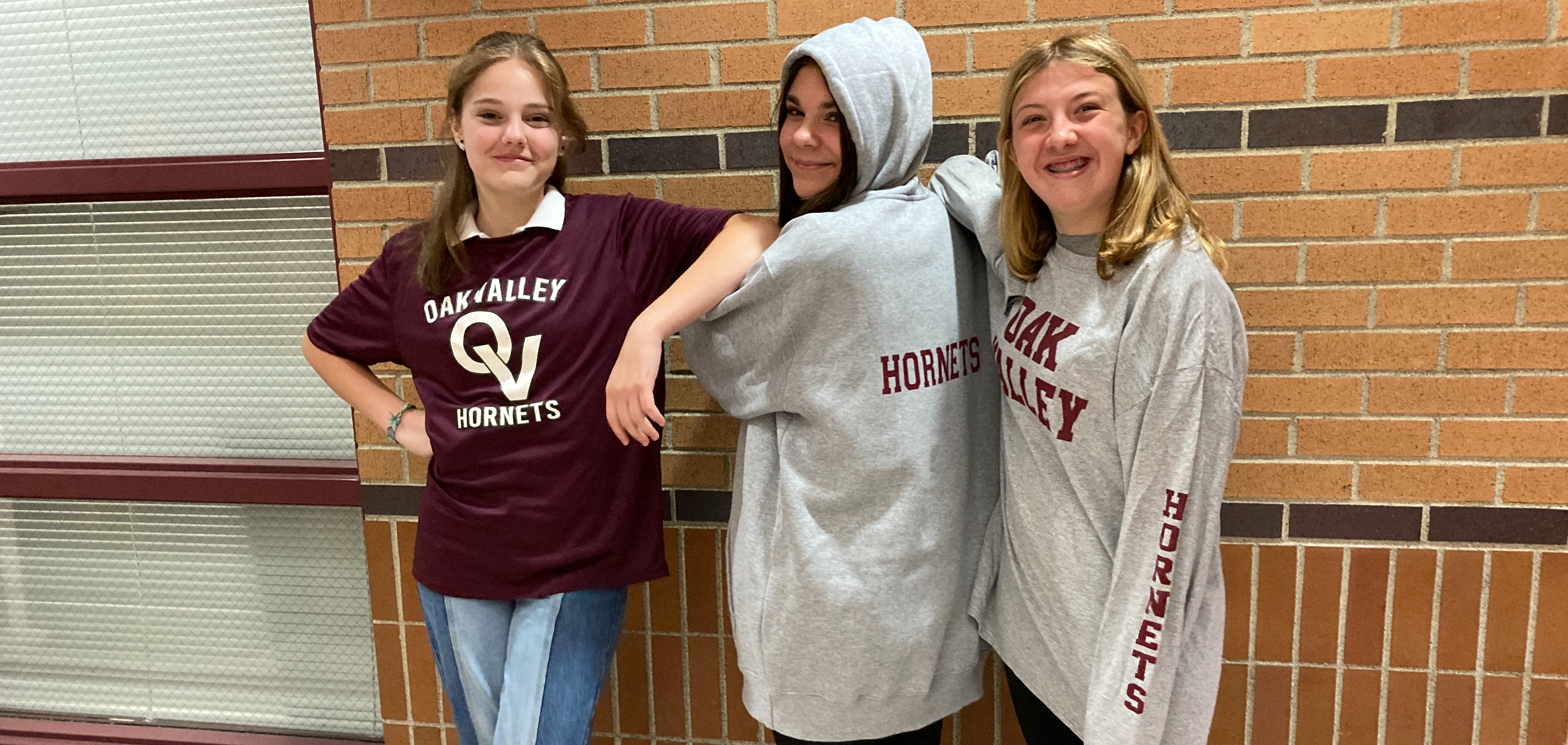 three girls wearing OV shirts