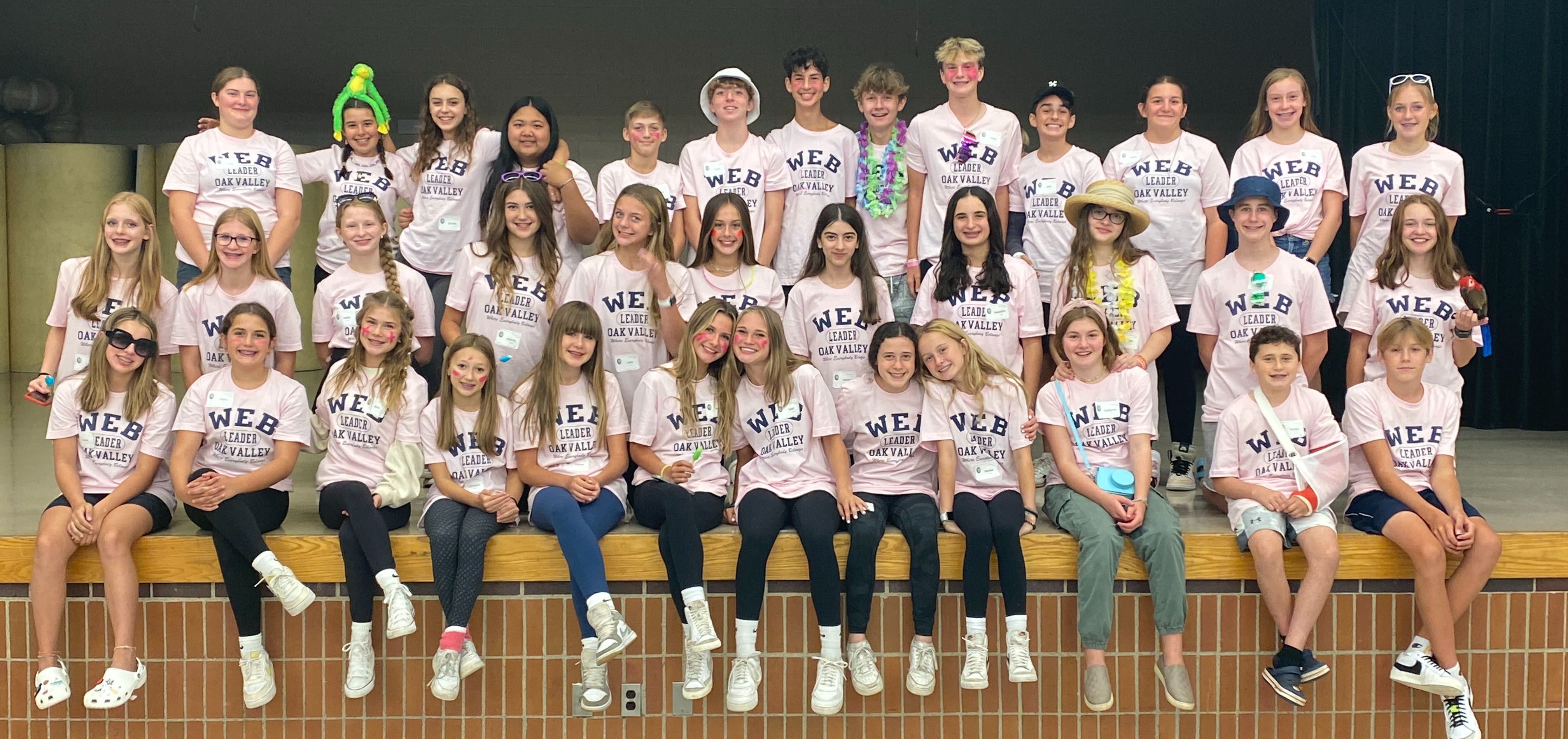 WEB leaders in group photo wearing pink t-shirts
