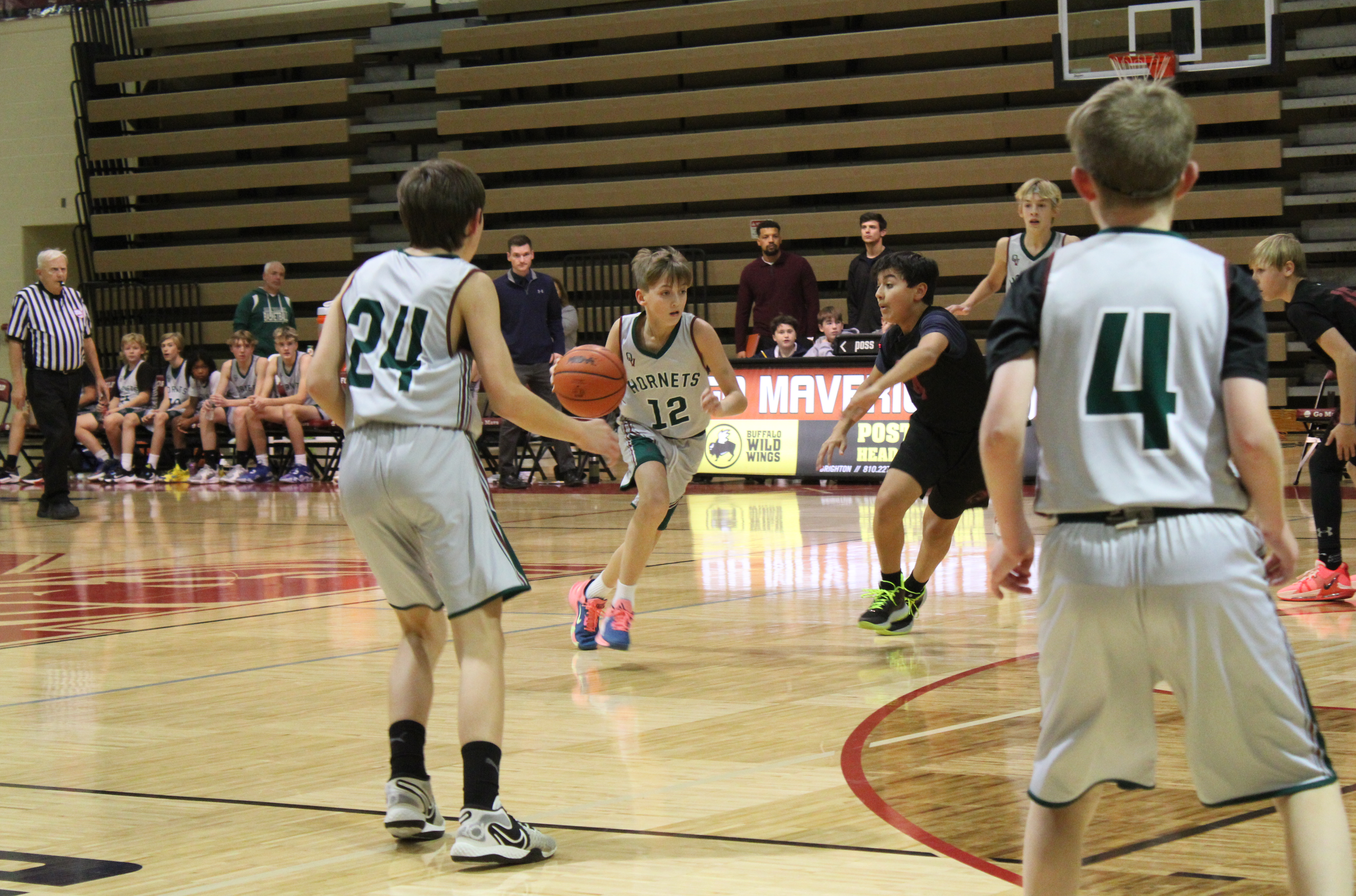boy dribbling down the court