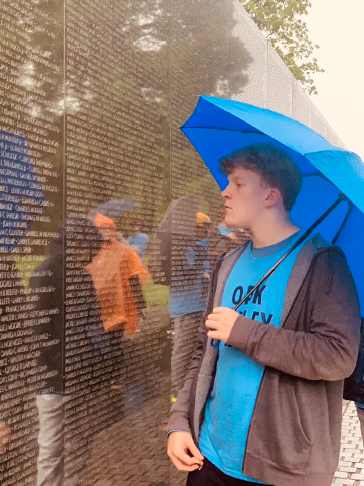 boy with umbrella at Viet Nam Memorial