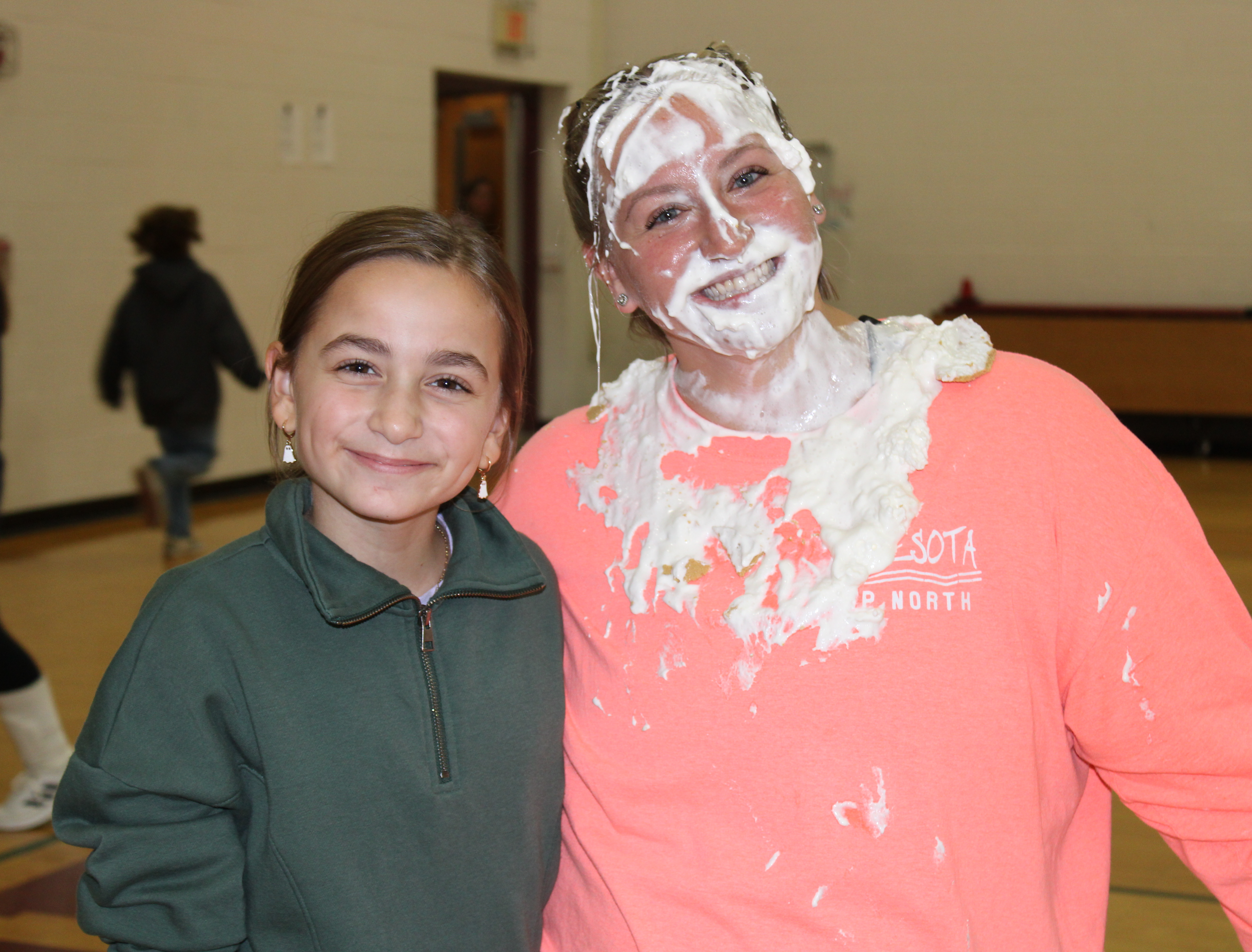 girl and assistant principal  with pie in the face