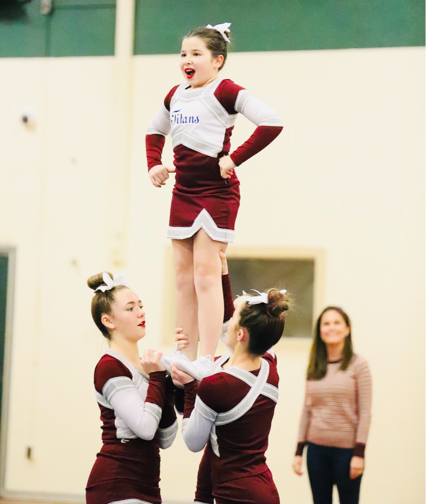 cheerleader lifted up by teammates