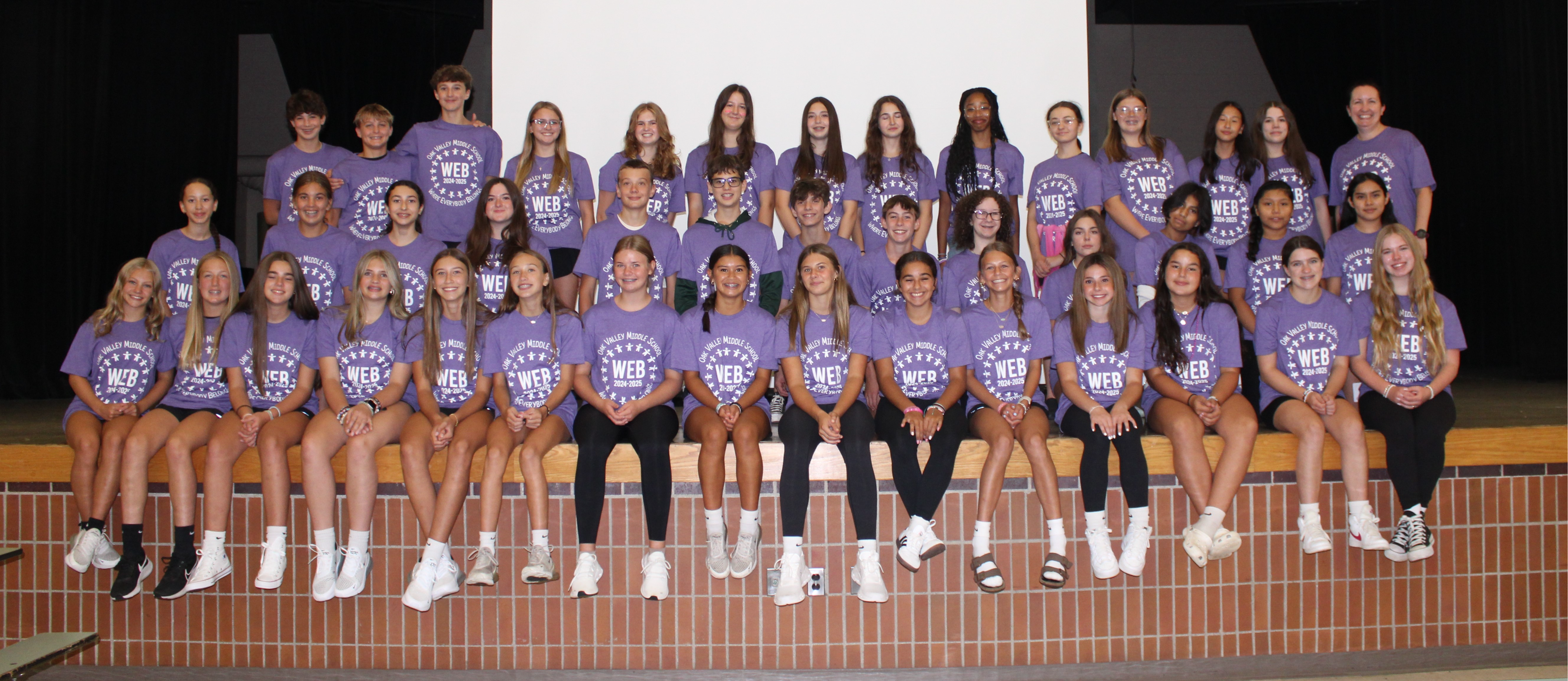 WEB leaders in group photo wearing pink t-shirts