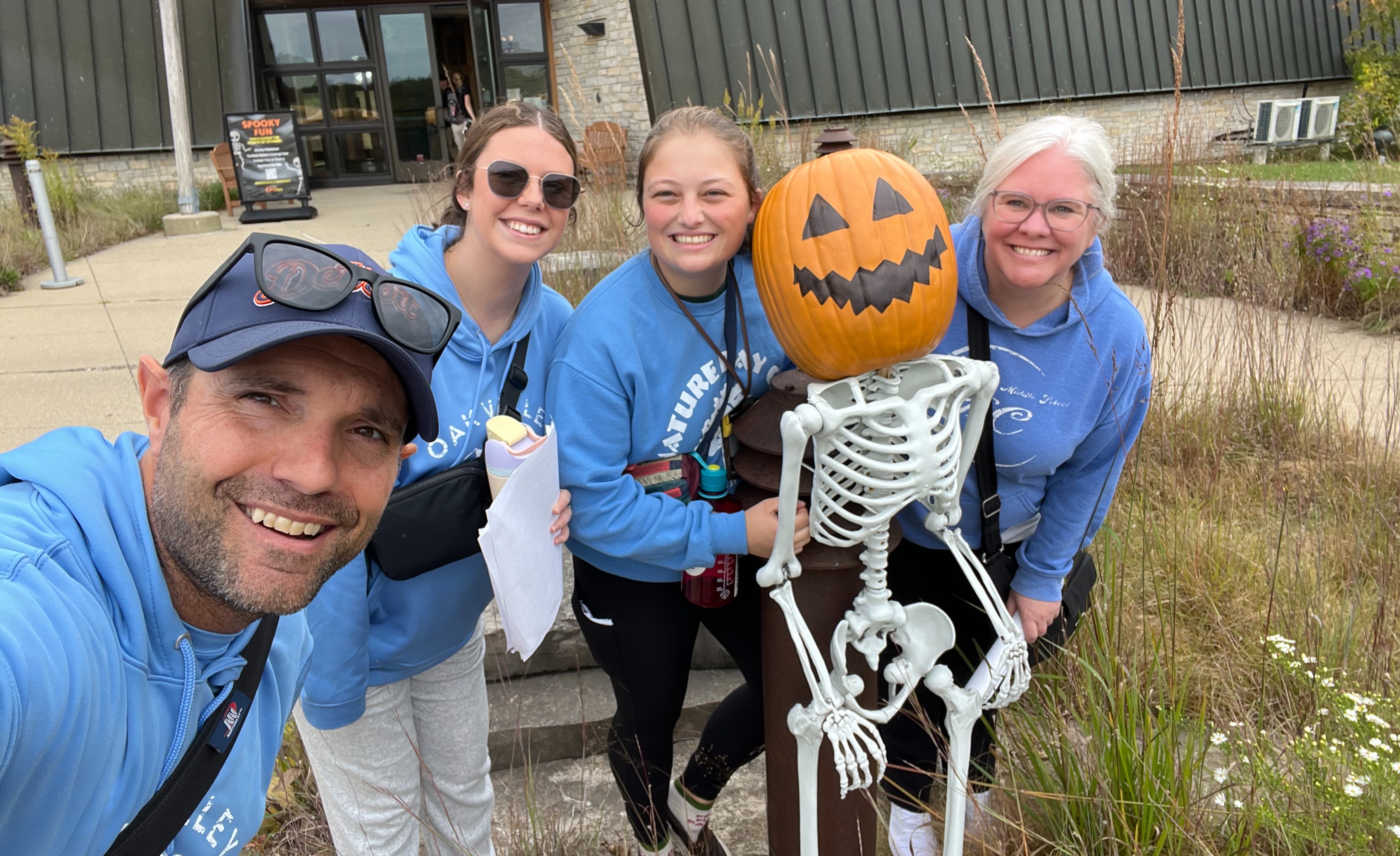 Science teachers pose with skeleton