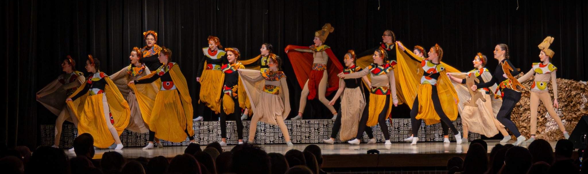 students in Lion King costumes on stage