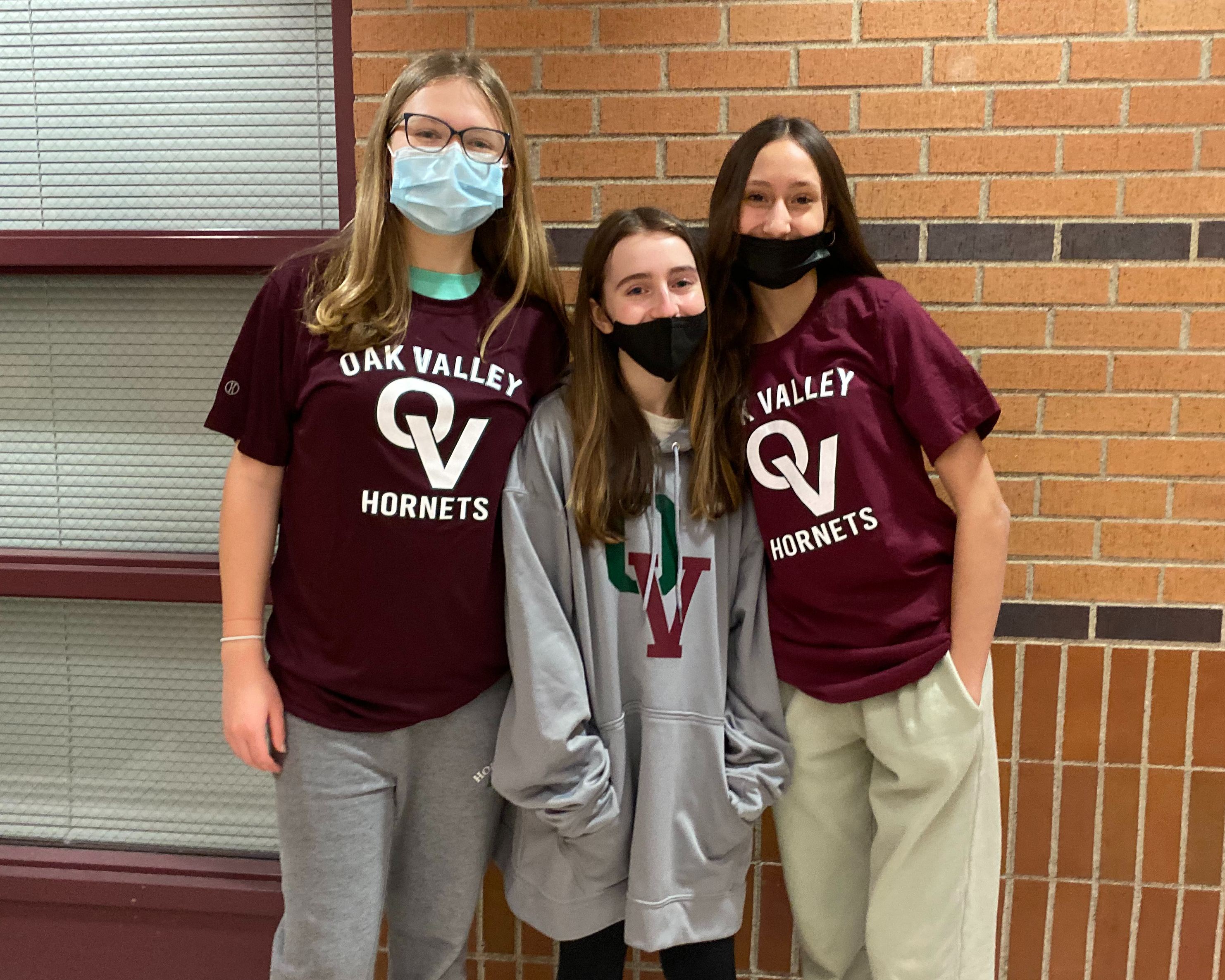 three girls wearing OV shirts