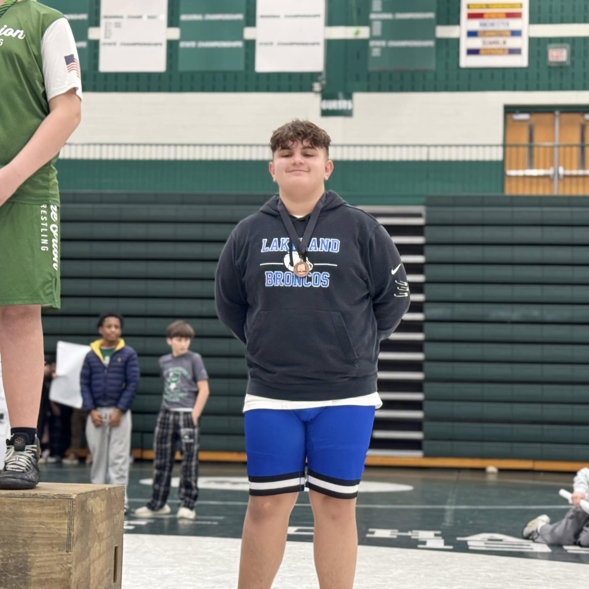 wrestler posing for photo during awards ceremony