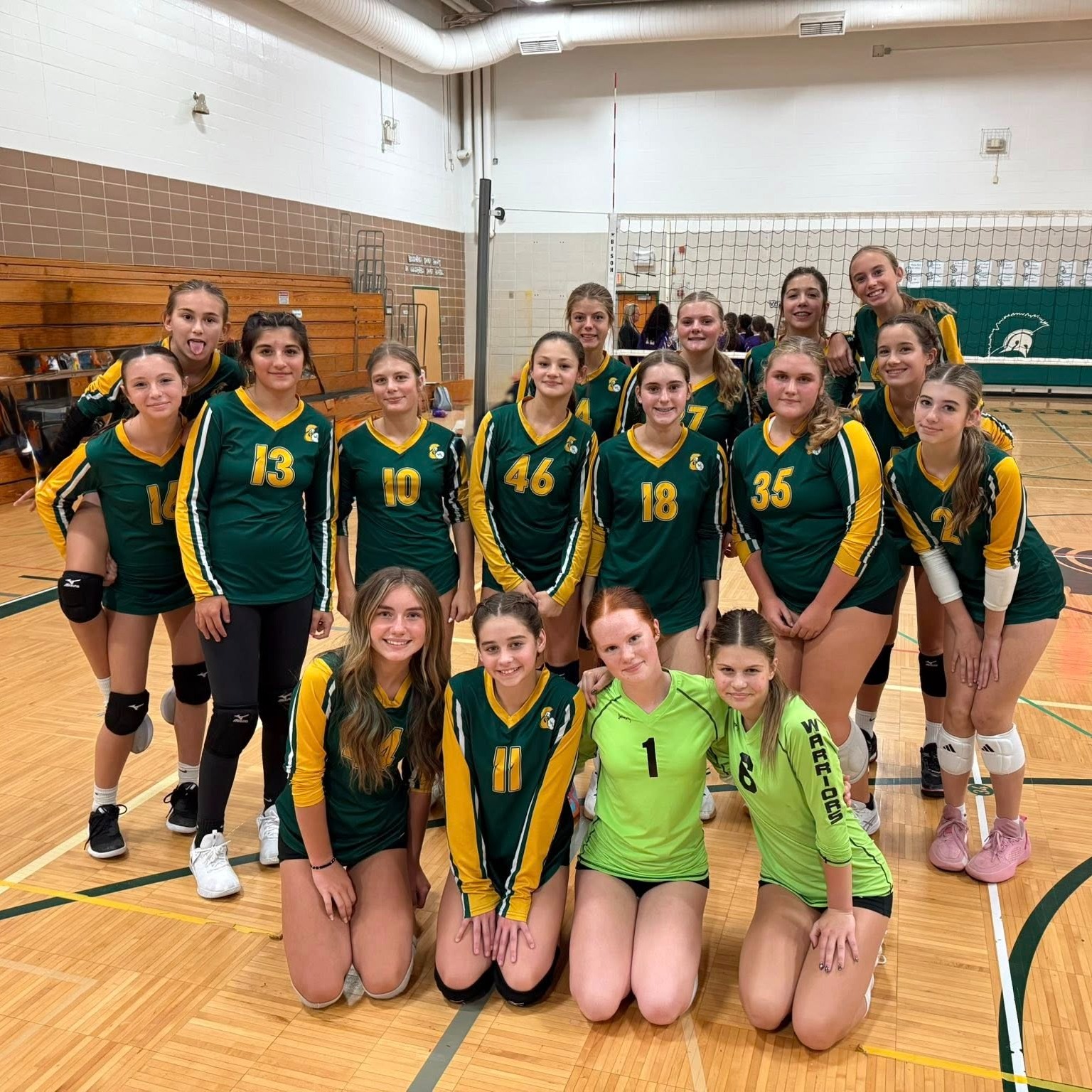 Girls volleyball team photo in gymnasium