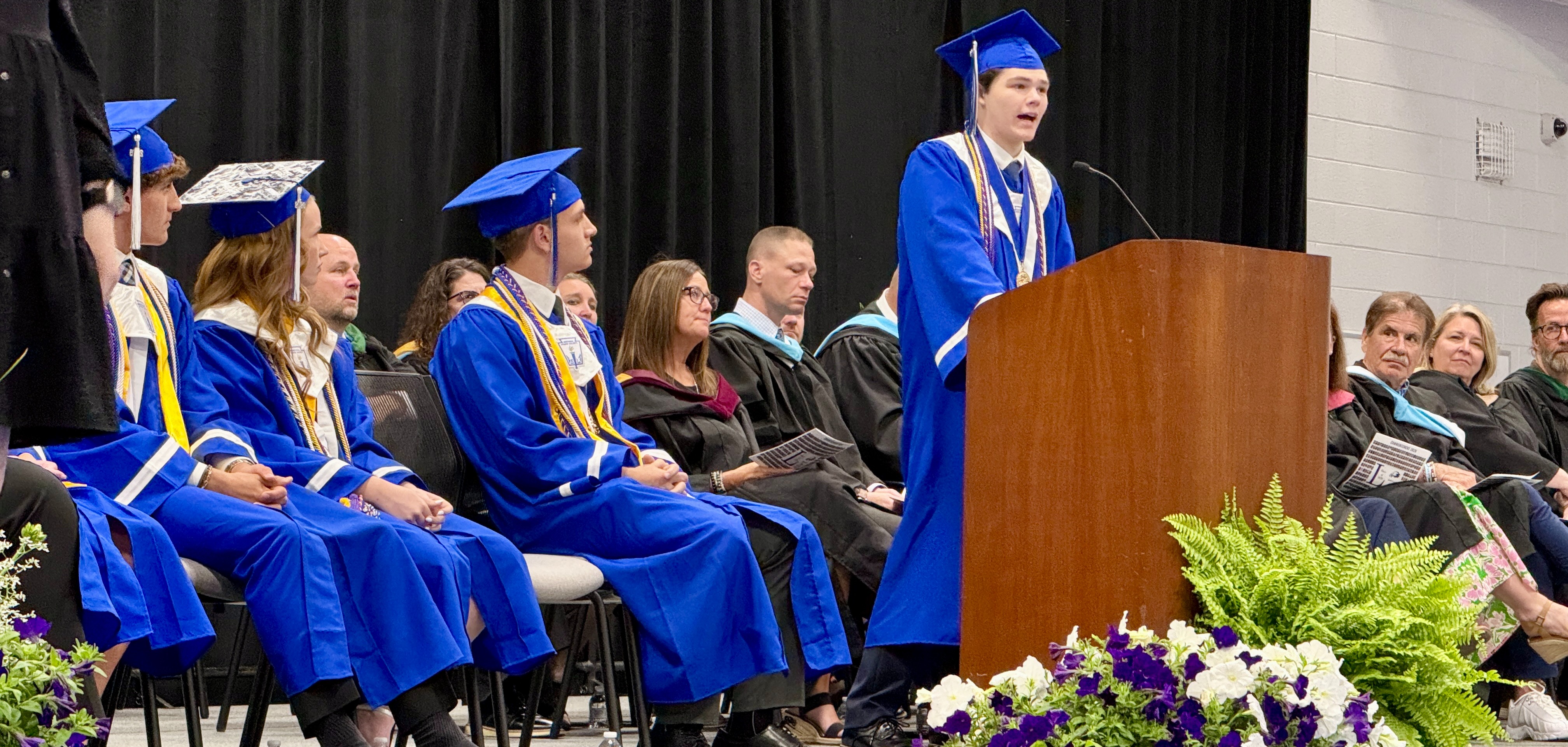 STUDENT SPEAKING AT GRADUATION IN CAP & GOWN