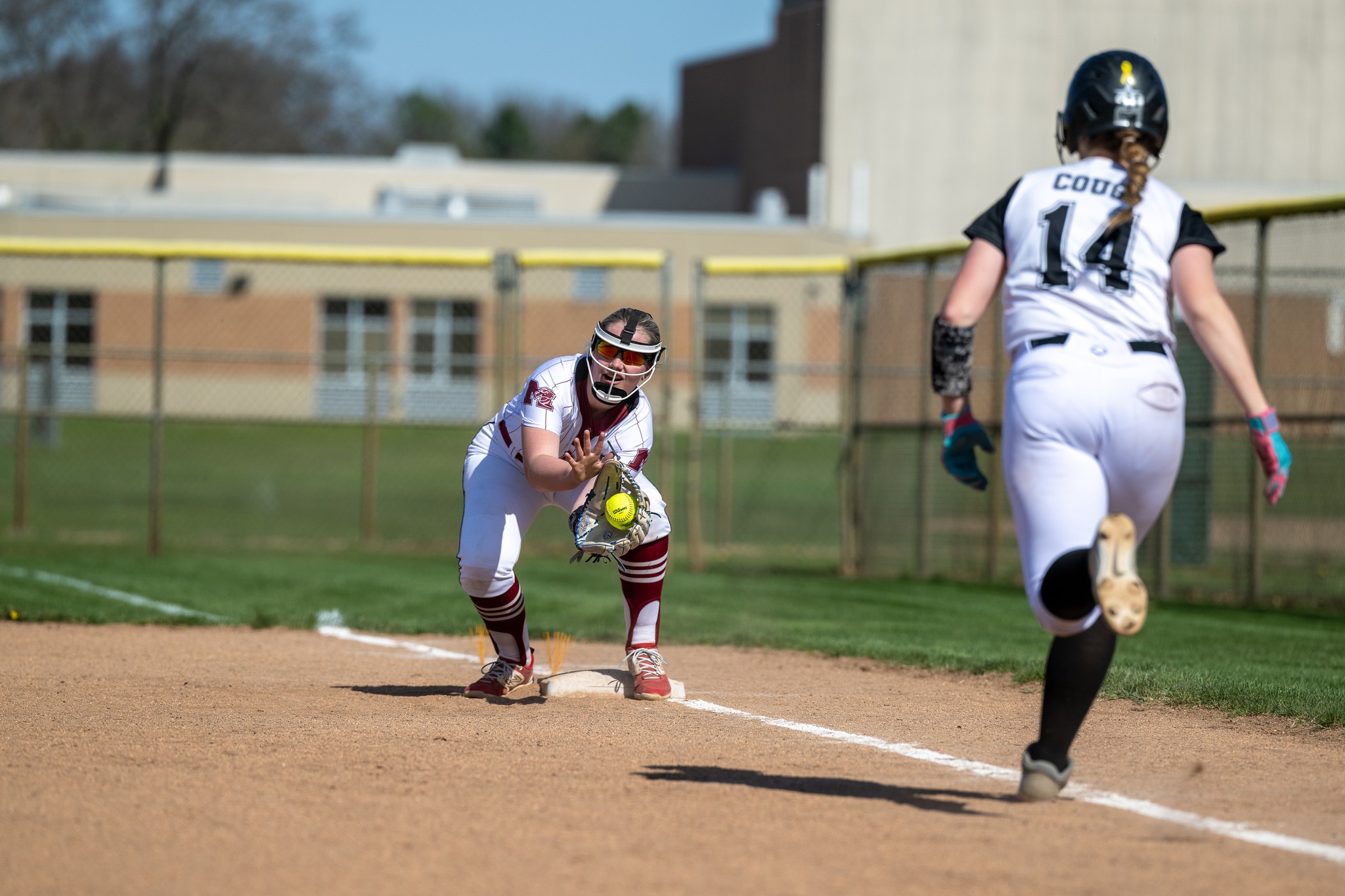 Milford softball player makes the out at first base.