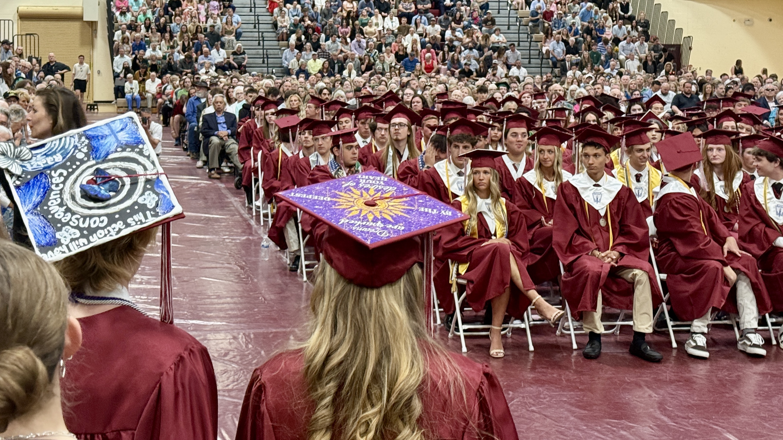 students in cap & gown at graduation ceremony