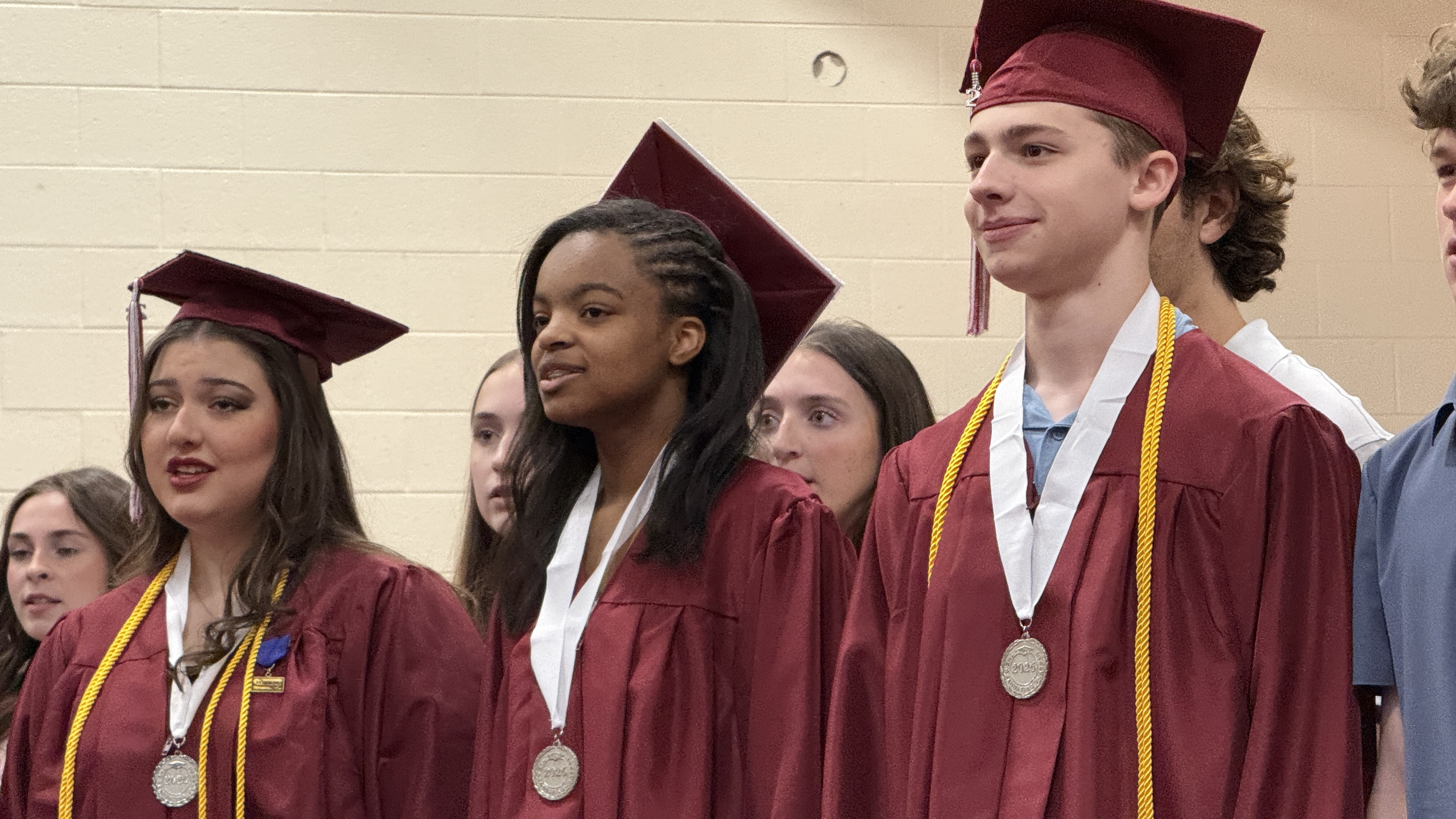 students in cap & gown at graduation ceremony