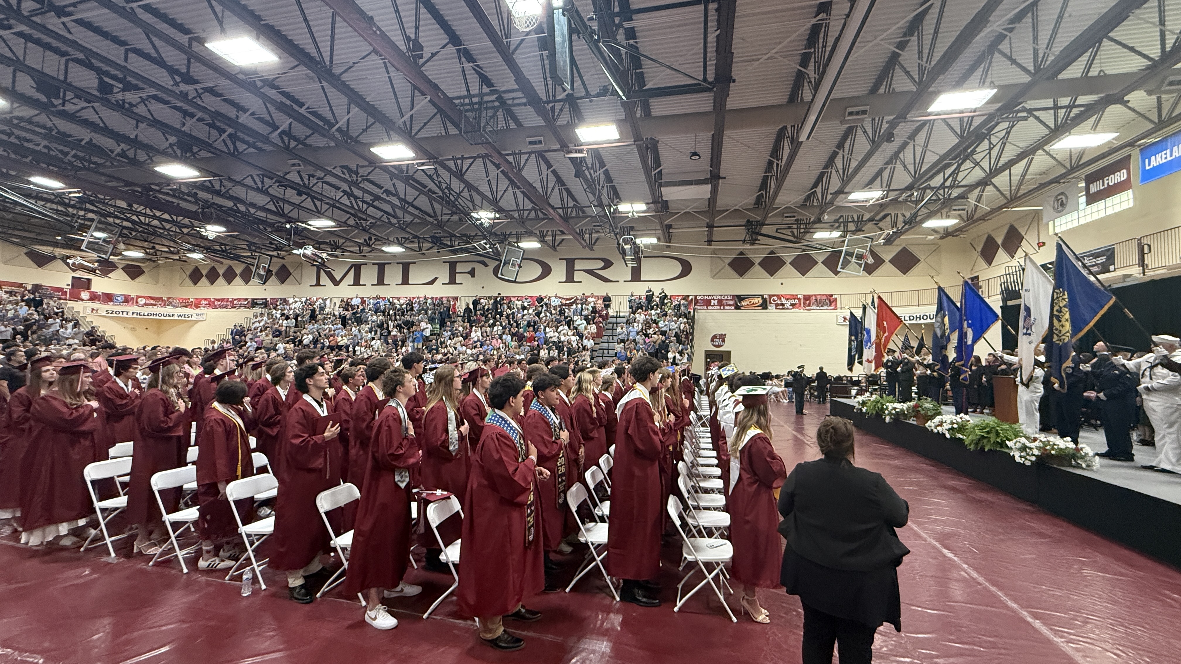 students in cap & gown at graduation ceremony
