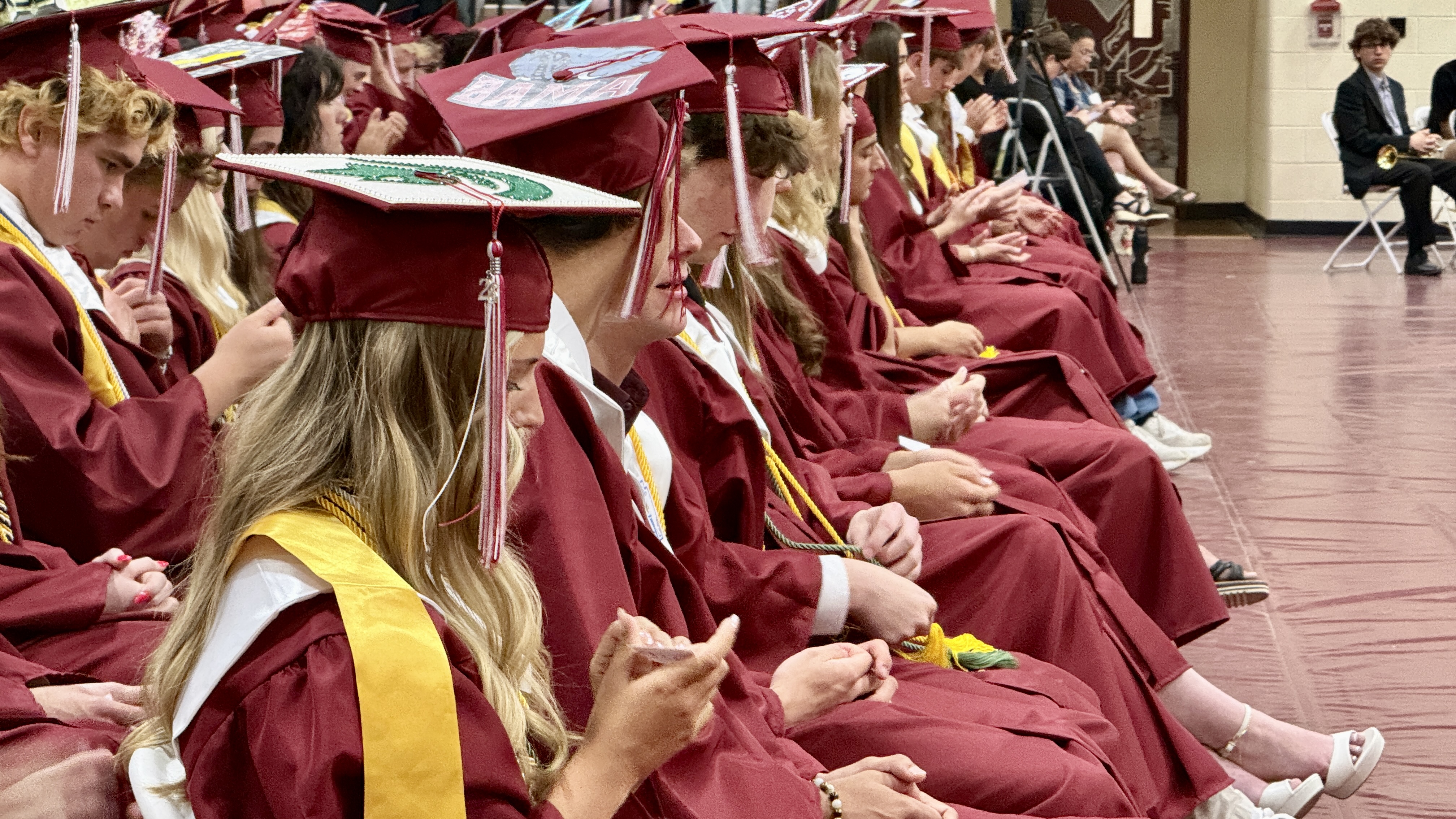 students in cap & gown at graduation ceremony