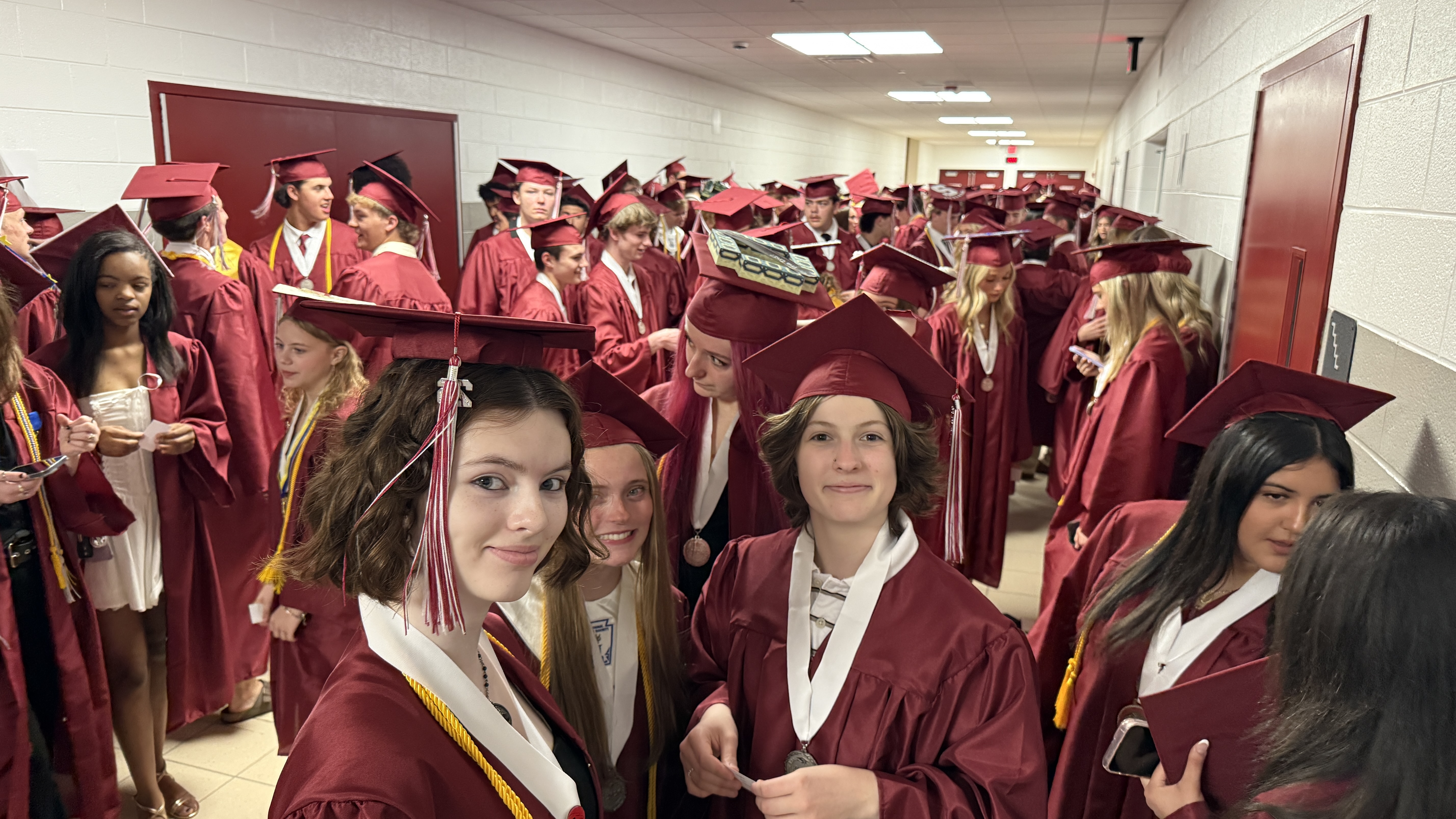 students in cap & gown at graduation ceremony