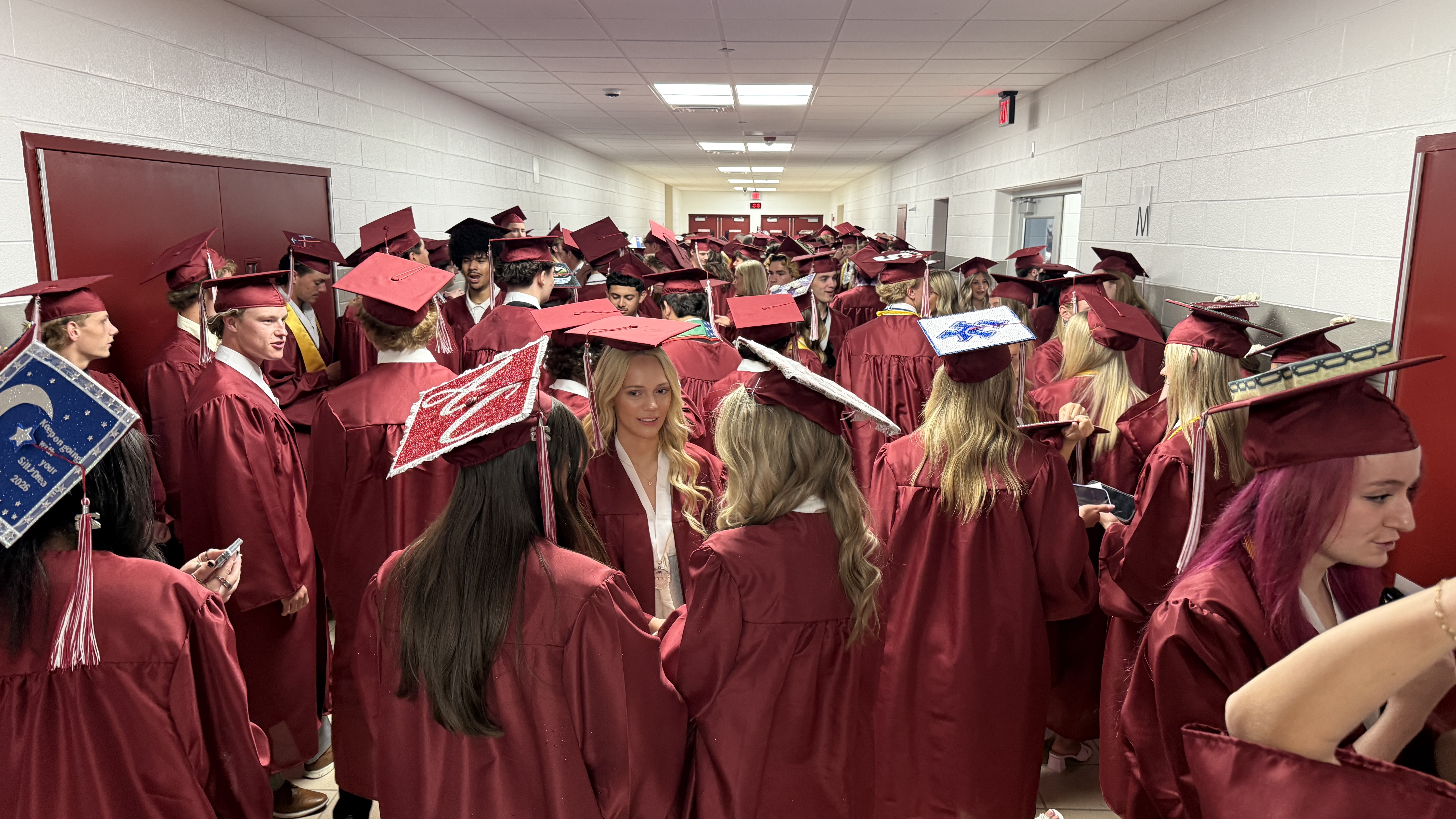 students in cap & gown at graduation ceremony
