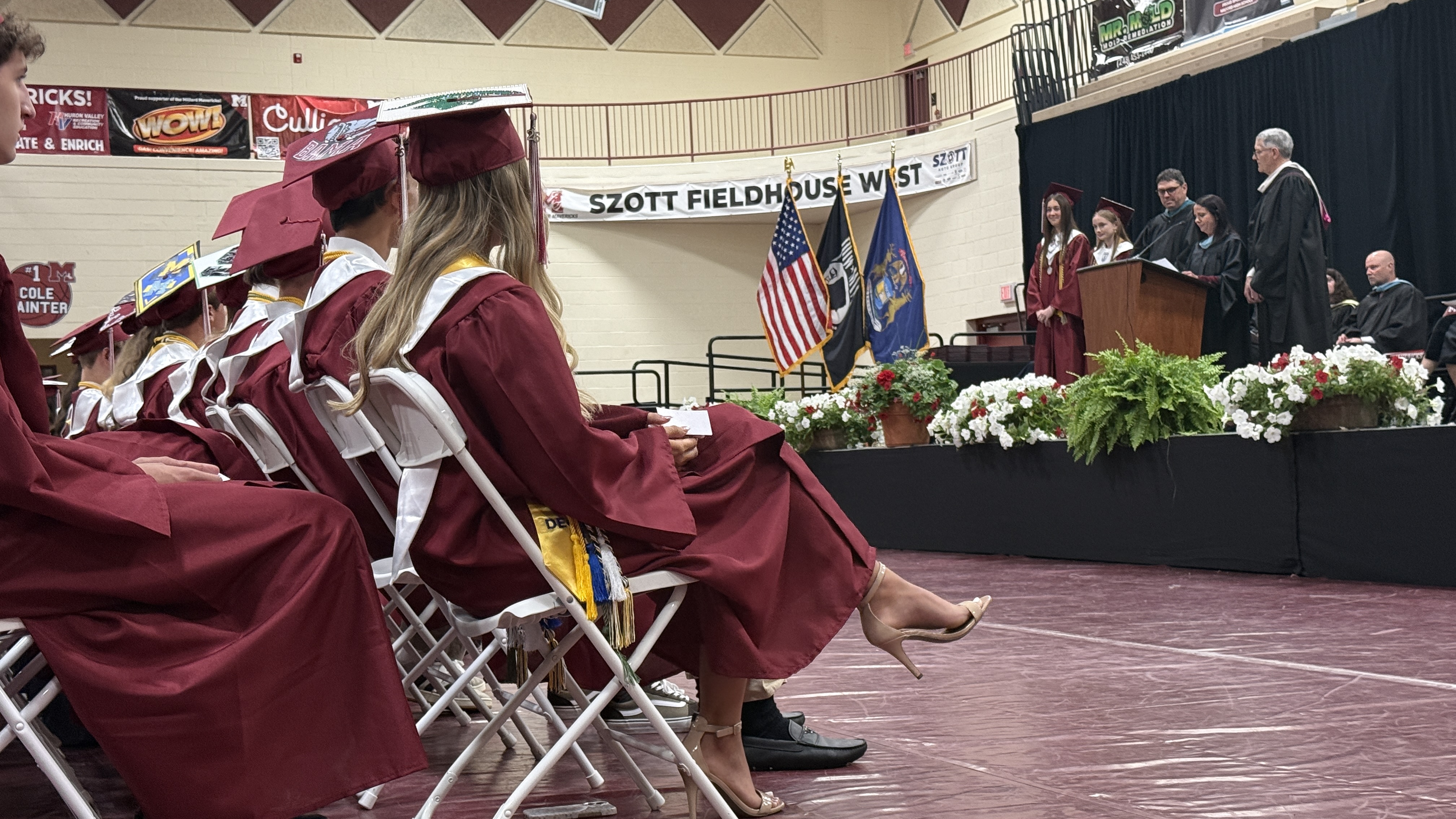students in cap & gown at graduation ceremony