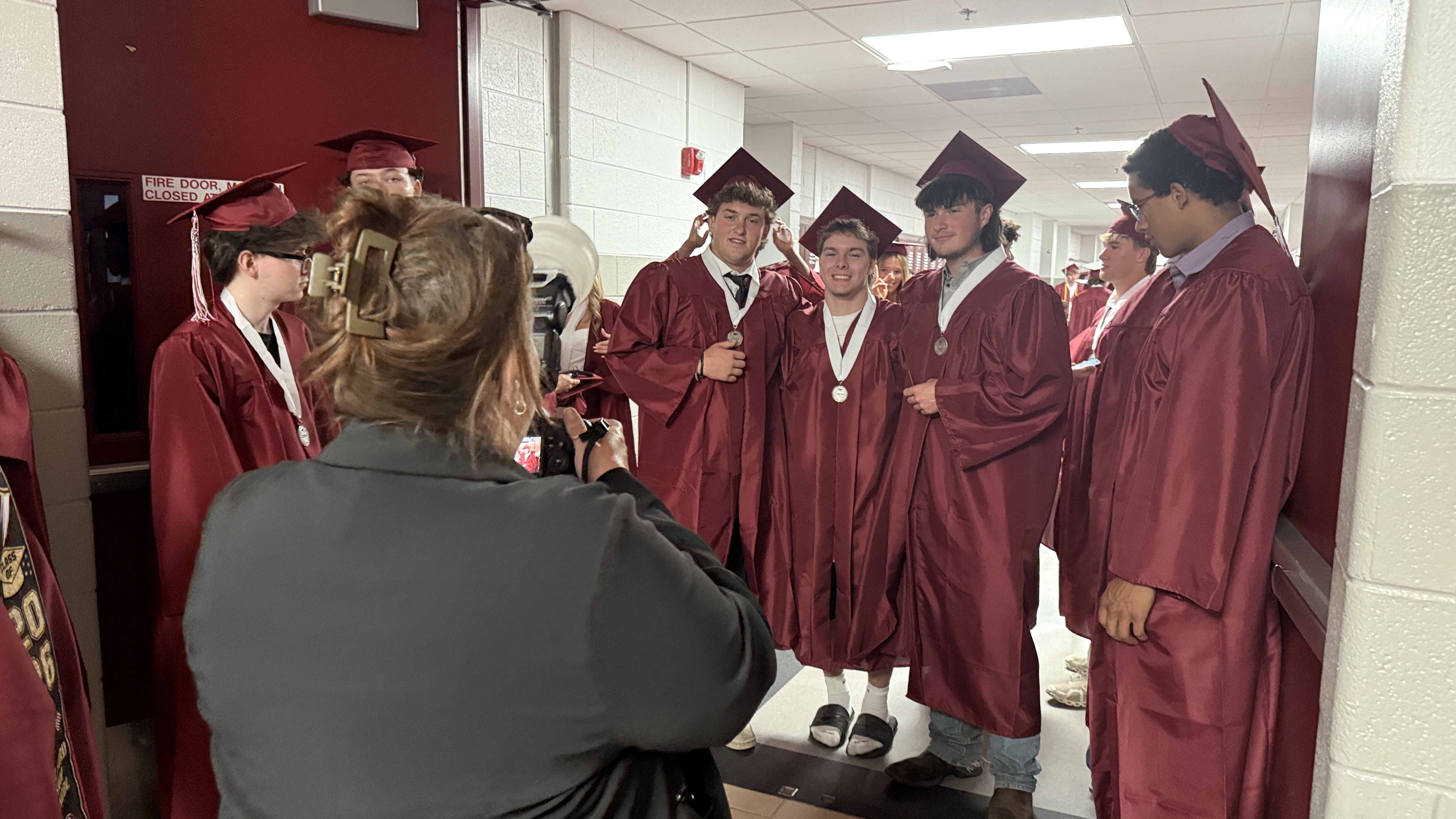 students in cap & gown at graduation ceremony