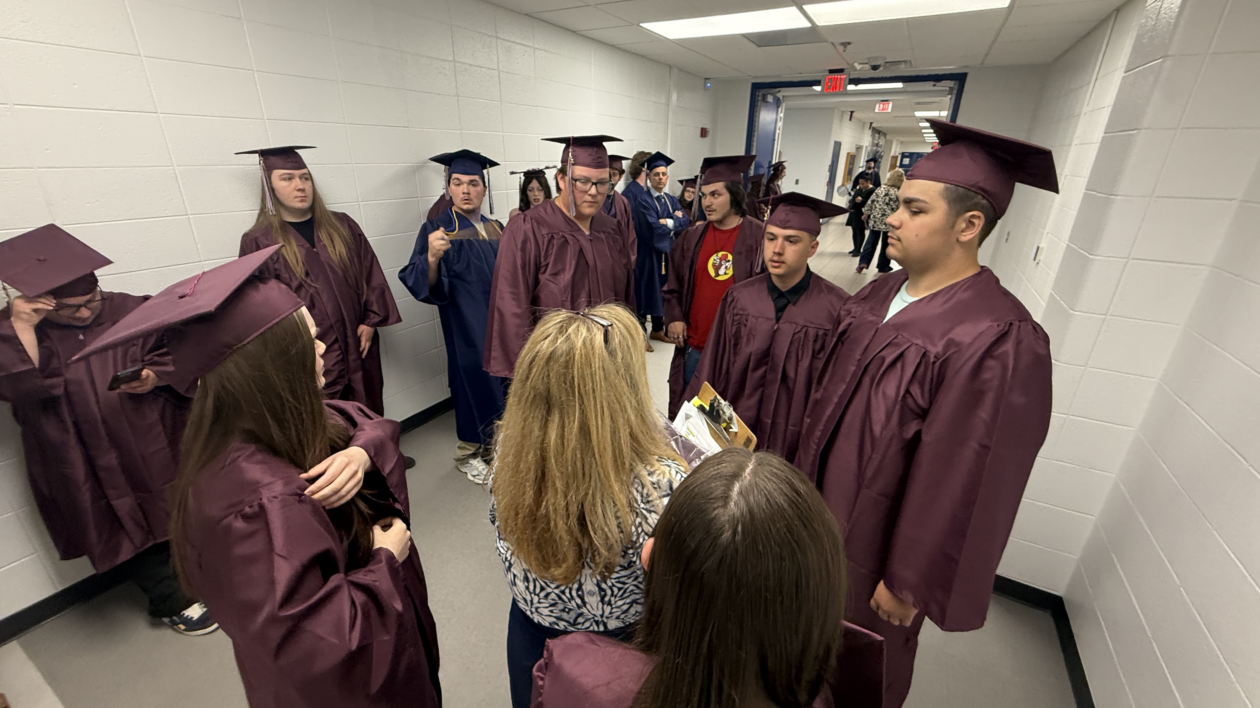 Students standing in their cap and gown for graduation