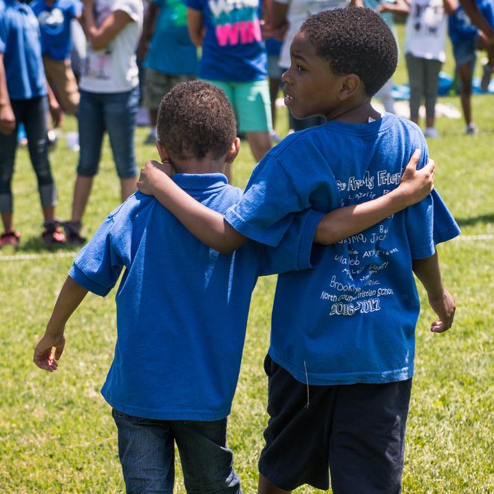 Two boys hugging