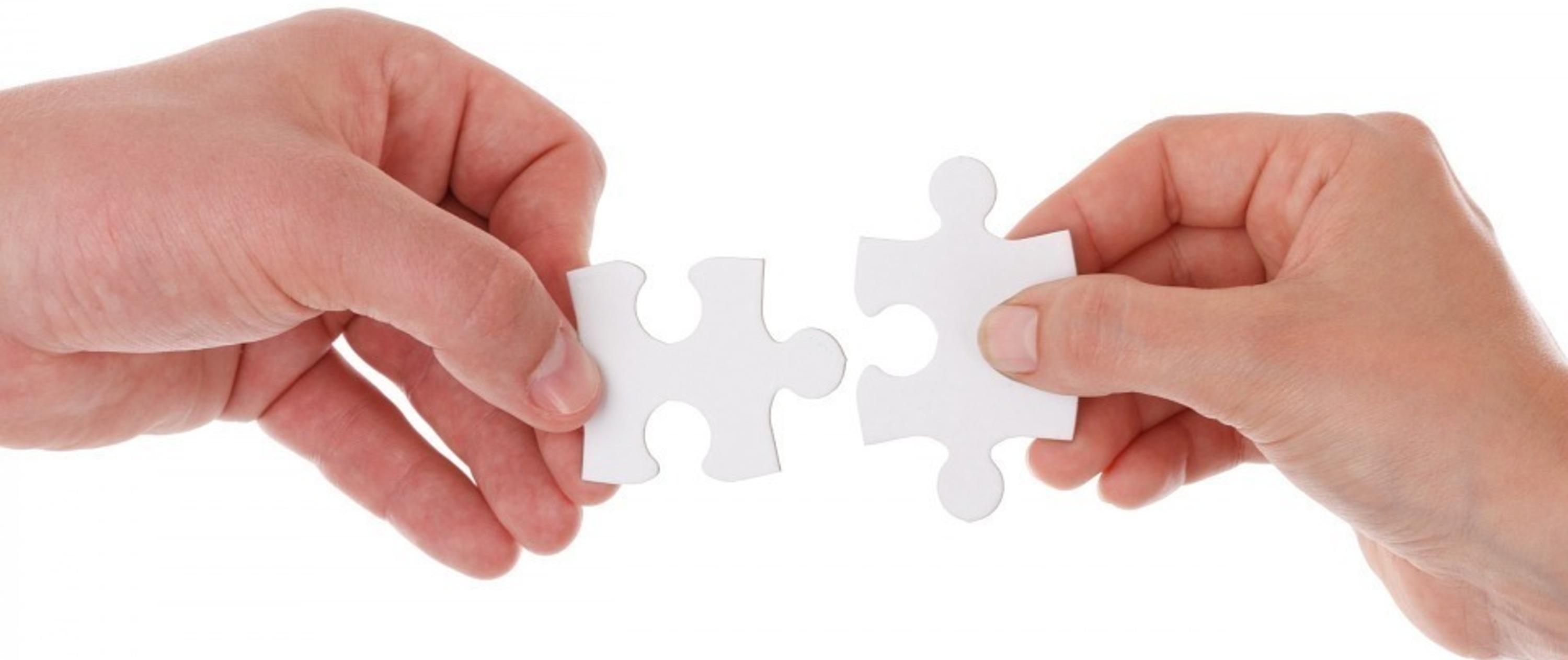 Hand joining a jigsaw puzzle