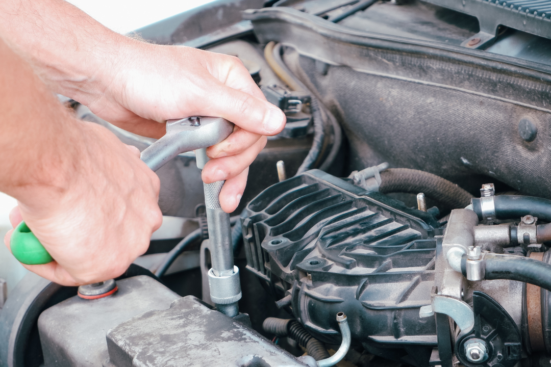 Auto Mechanic.  Person working on car