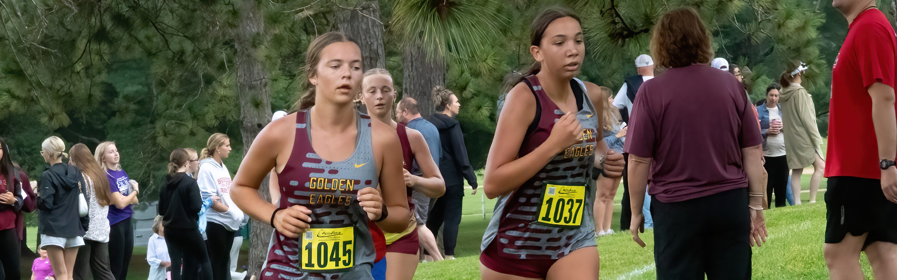 A couple of varsity cross country athletes run side by side during a recent girls race