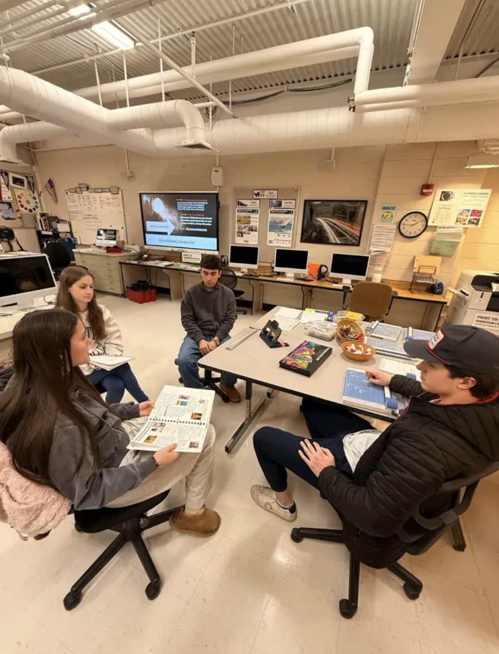 Students sitting together in film class working on project