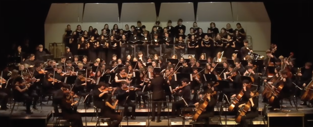 Choir, band, and orchestra performing