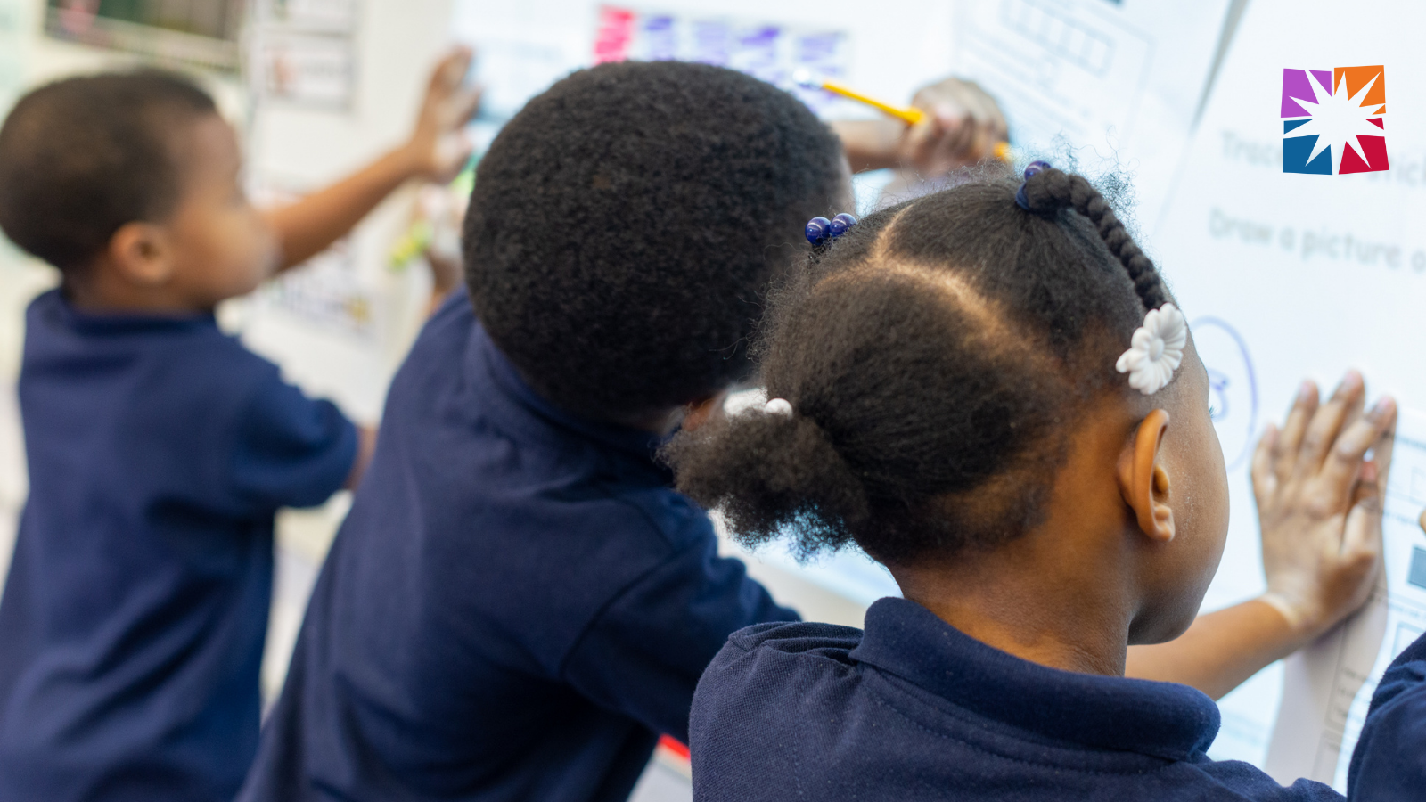 Students working at the white board