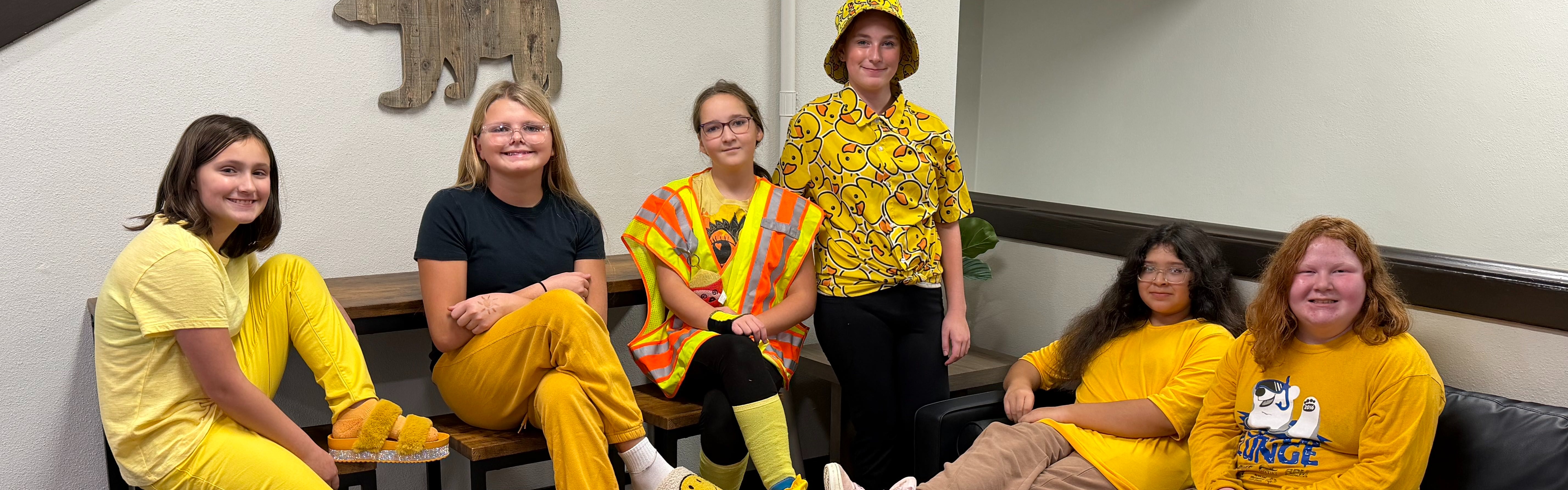 6th grade girls dressed in yellow for hoco