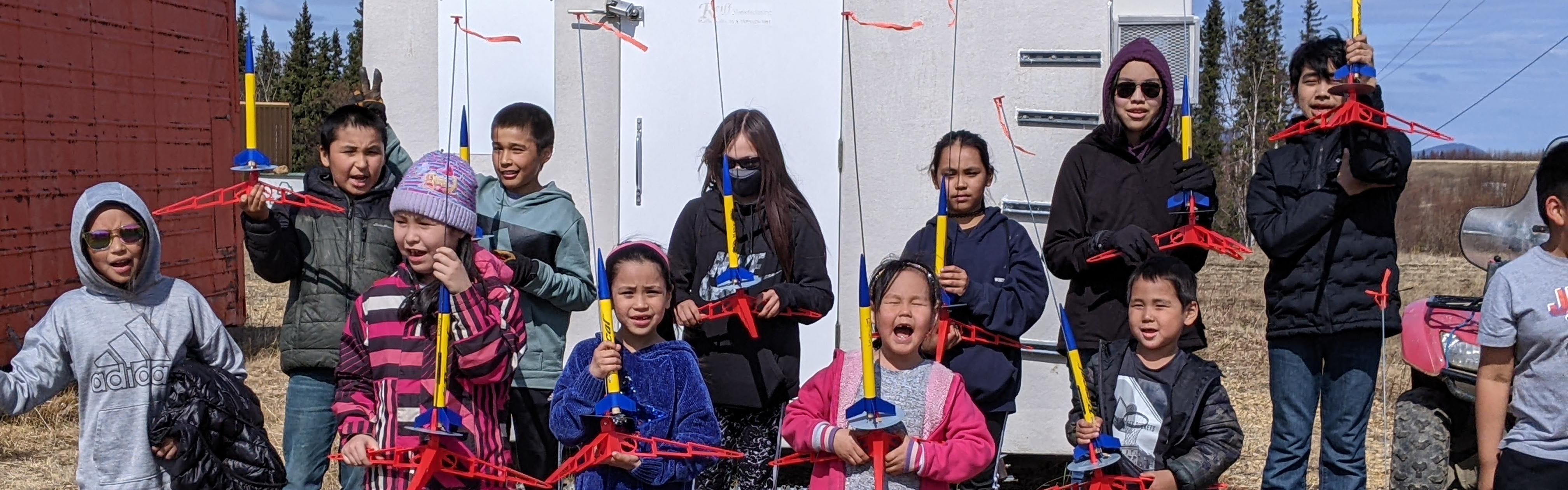 students with toy rockets