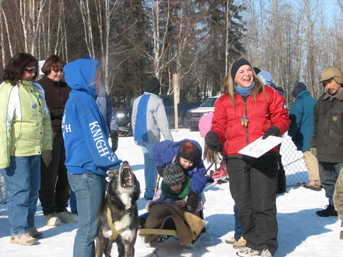 photo of people around a dog sled