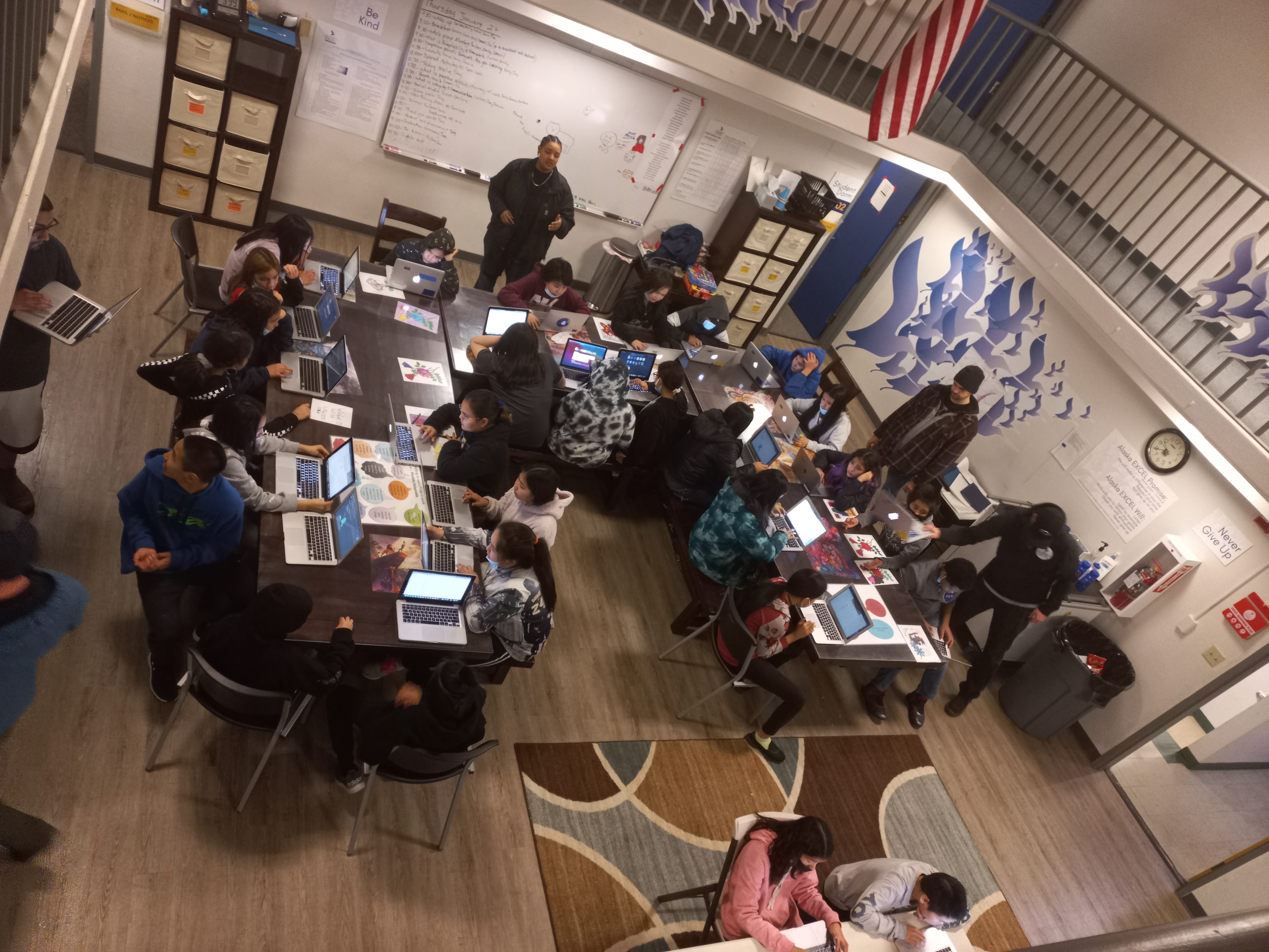 overhead shot of students working indoors at desks