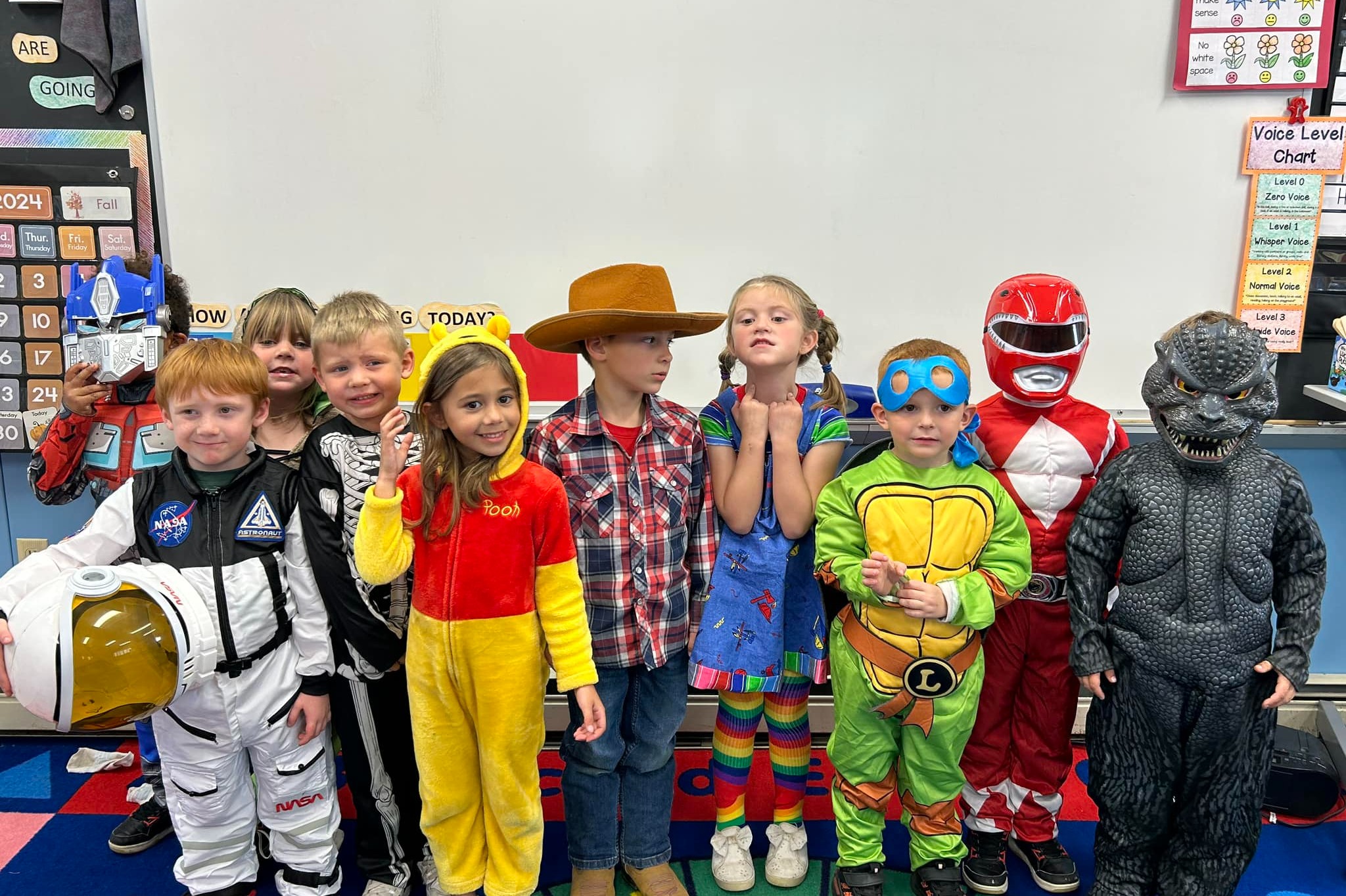 Preschool children dressed in green.