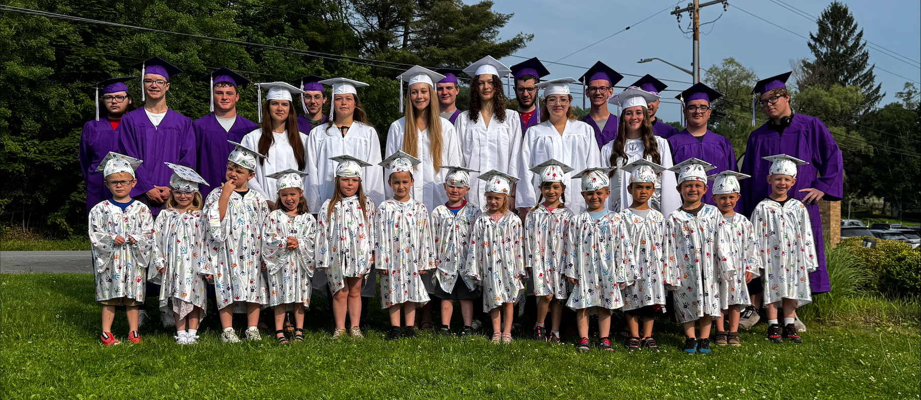 prek and seniors in caps and gowns