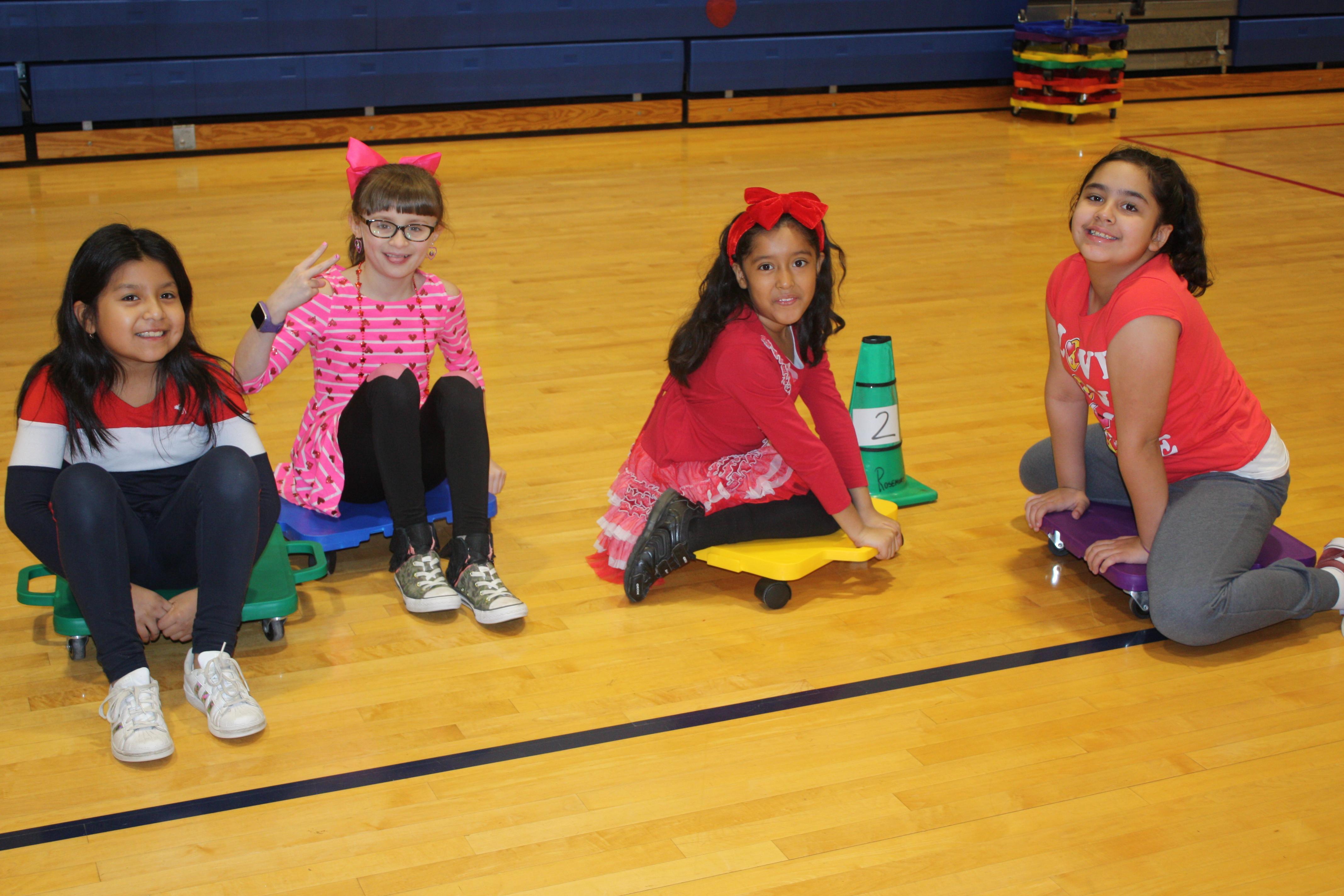 Students sitting together in the gym during PE class