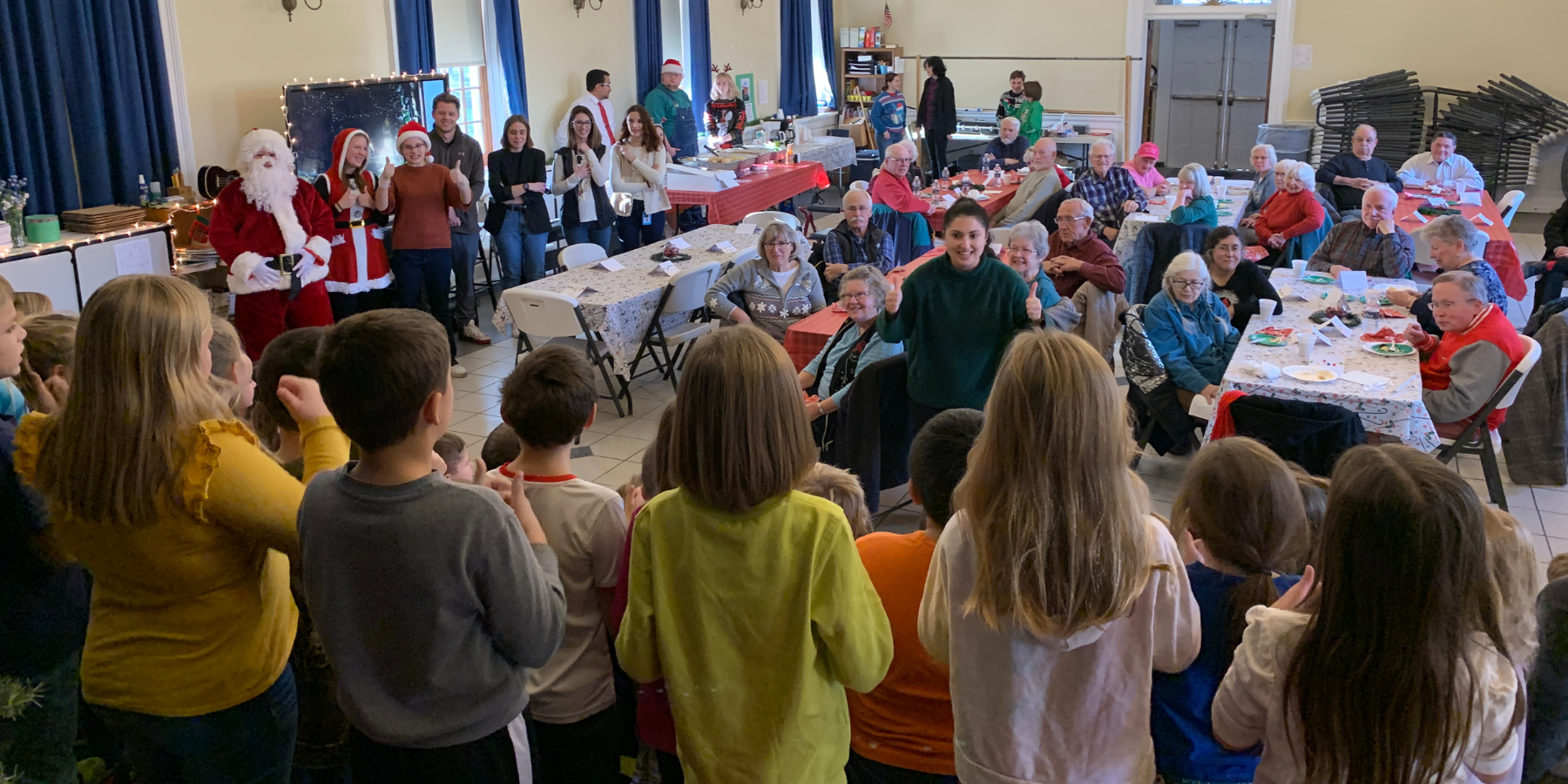 community members gater in an auditorium for a holiday meal