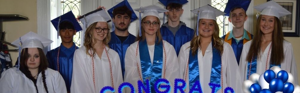 Class of 2026 graduates dressed in blue and white caps and gowns 