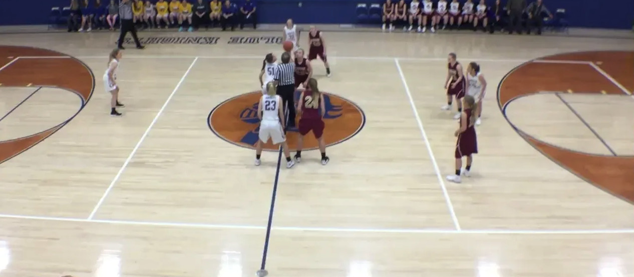 Two girls basketball team at center court for tip off