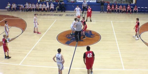 Two boys basketball teams playing basketball at the center