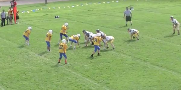 Two junior high school boys football teams playing football