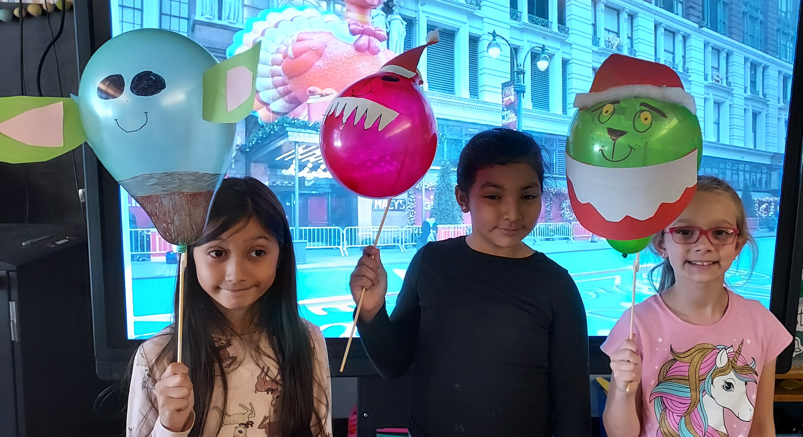 students pose with decorated balloons