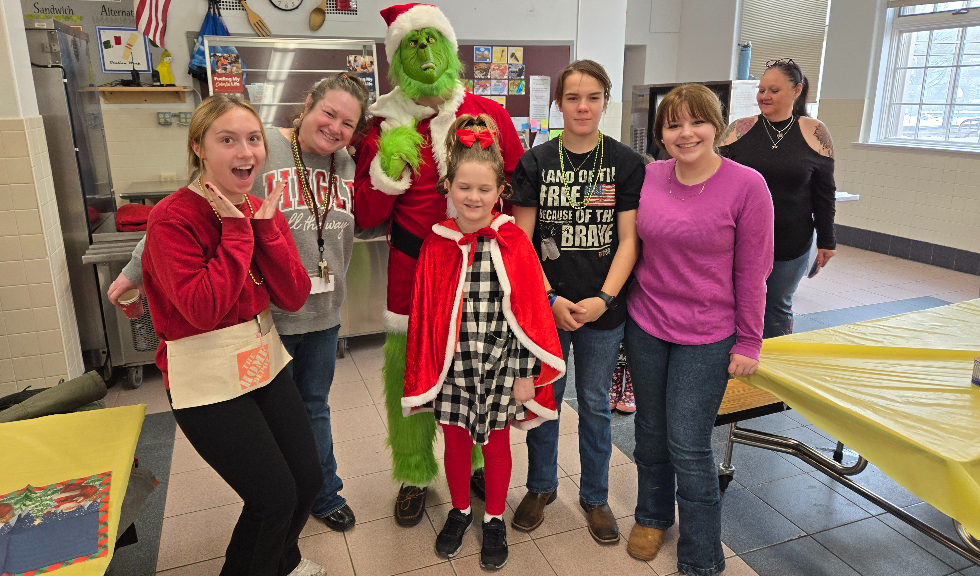 People pose with The Grinch and Cindylou Who