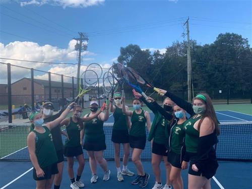 Girl Tennis team with rackets up