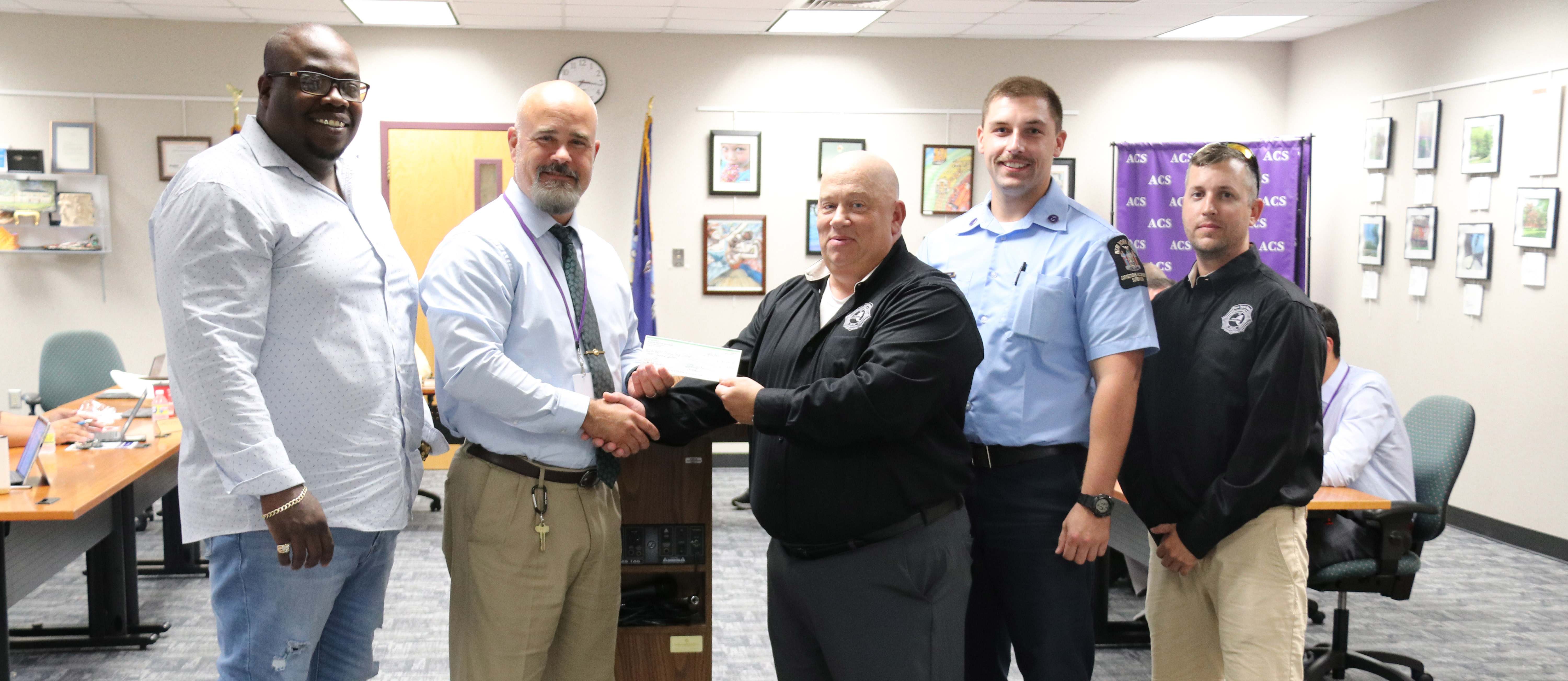 NYSCOPBA hands check to ACS Superintendent.